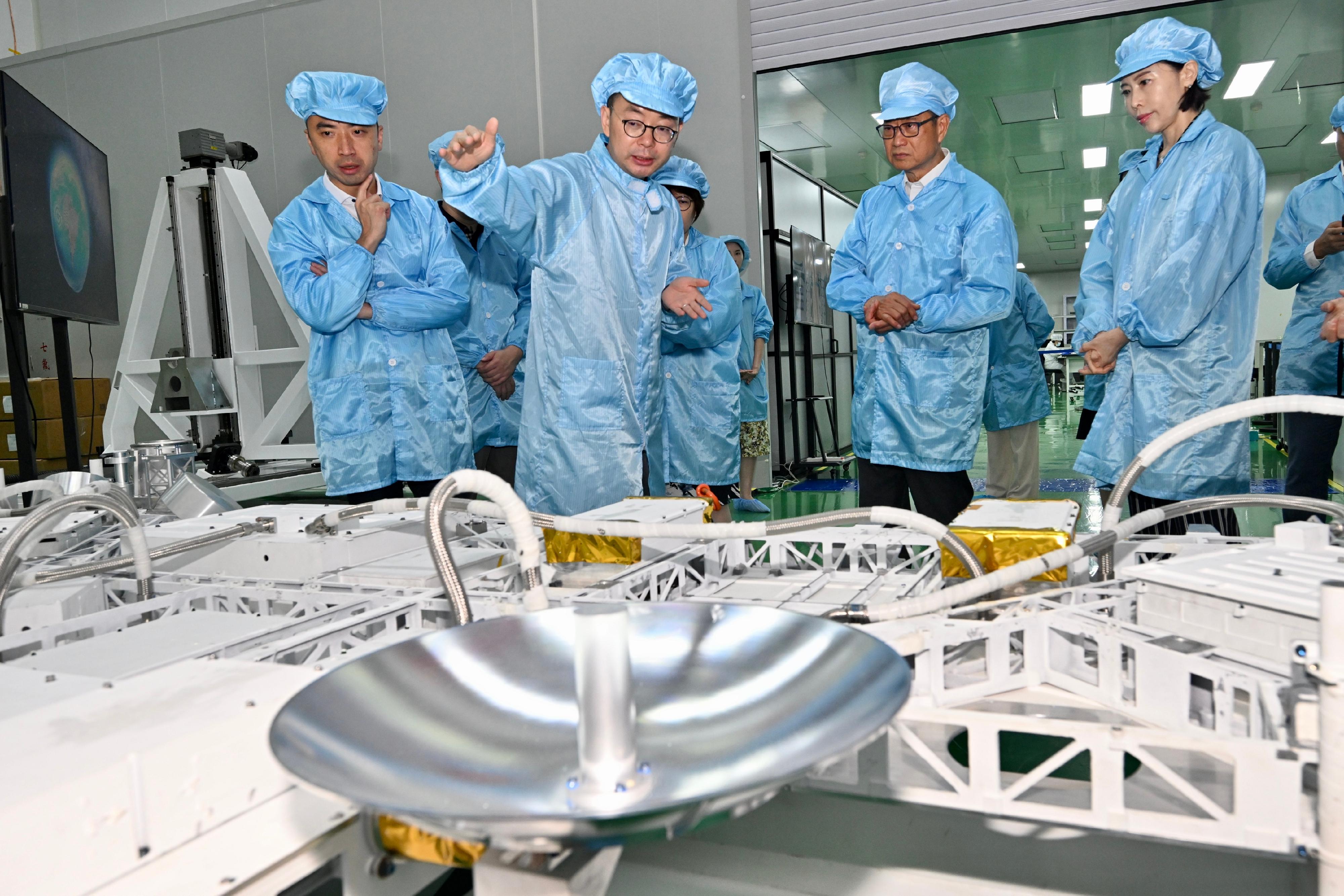 The Financial Secretary, Mr Paul Chan, continued his visit in Beijing today (July 12). Photo shows Mr Chan (second right) visiting an enterprise which manufactures satellites and offers satellite Internet solutions. He toured its research and development centre and viewed new generation satellite products.