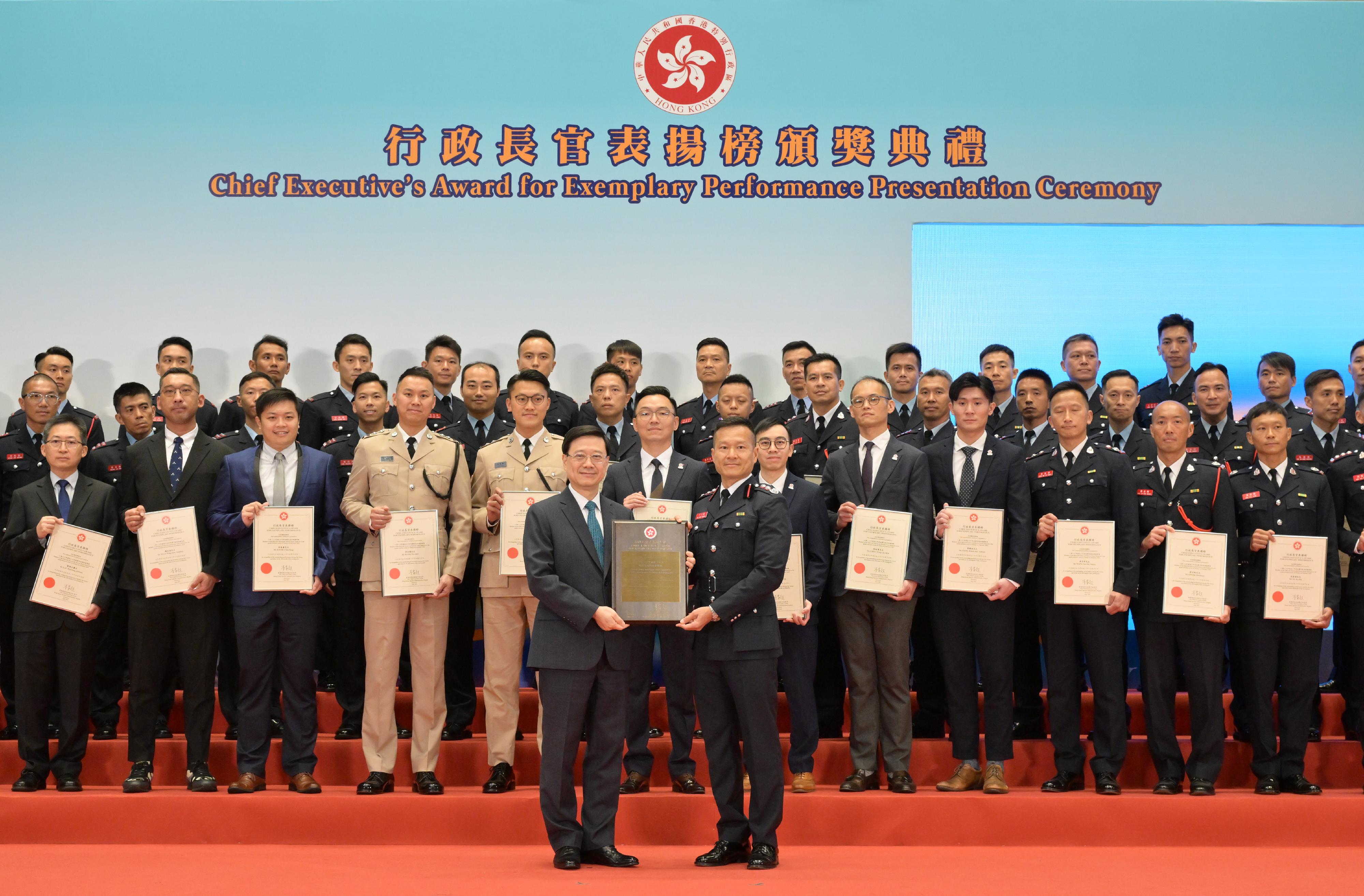 The Chief Executive, Mr John Lee, presented commendation certificates to the Hong Kong Special Administrative Region (HKSAR) search and rescue team deployed to quake-stricken areas of Türkiye in 2023 at the Chief Executive's Award for Exemplary Performance Presentation Ceremony today (July 13). Photo shows Mr Lee (front row, left) presenting a commendation certificate to the Commander of the HKSAR search and rescue team, Mr Yiu Men-yeung (front row, right).
