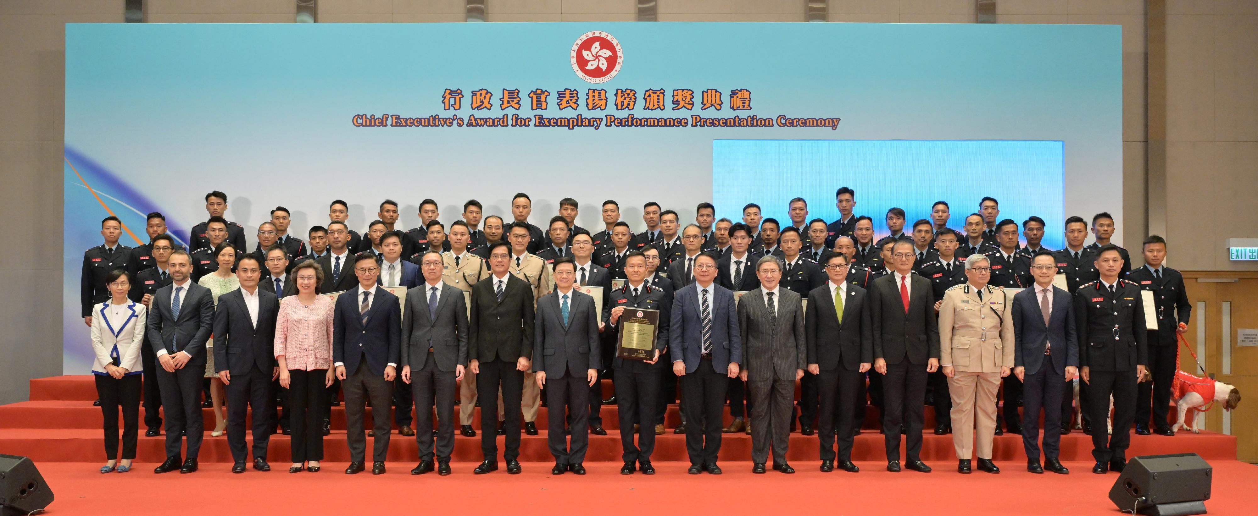 The Chief Executive, Mr John Lee, attended the Chief Executive's Award for Exemplary Performance Presentation Ceremony today (July 13). Photo shows (front row, from first left) the Chairman of the Public Service Commission, Ms Maisie Cheng; the Consul General of Türkiye in Hong Kong, Mr Peyami Kalyoncu; the Chairman of the Legislative Council's Panel on Public Service, Mr Kwok Wai-keung; the Secretary for the Civil Service, Mrs Ingrid Yeung; the Deputy Secretary for Justice, Mr Cheung Kwok-kwan; the Secretary for Justice, Mr Paul Lam, SC; the Acting Financial Secretary, Mr Michael Wong; Mr Lee; the Commander of the Hong Kong Special Administrative Region (HKSAR) search and rescue team deployed to quake-stricken areas of Türkiye in 2023, Mr Yiu Men-yeung; the Chief Secretary for Administration, Mr Chan Kwok-ki; the Deputy Chief Secretary for Administration, Mr Cheuk Wing-hing; the Secretary for Security, Mr Tang Ping-keung; the Secretary for Health, Professor Lo Chung-mau; the Director of Immigration, Mr Au Ka-wang; the Director of Health, Dr Ronald Lam; the Director of Fire Services, Mr Andy Yeung, and the awarded members and rescue dogs of the HKSAR search and rescue team deployed to quake-stricken areas of Türkiye in 2023 at the ceremony.