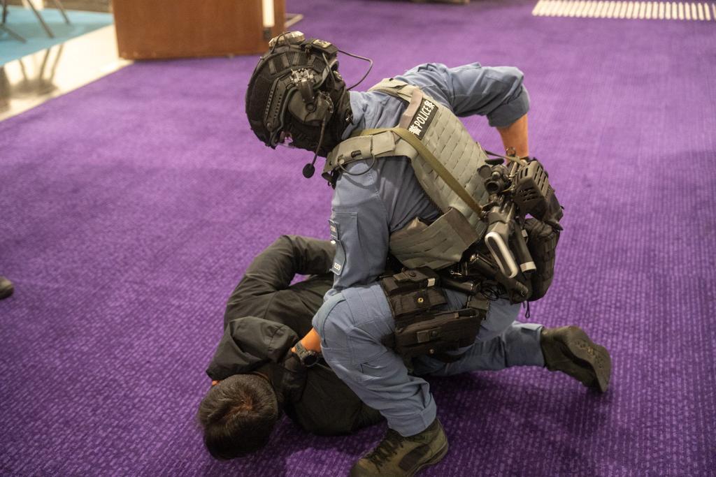 Police held a counter-terrorism exercise codenamed "PURPLEFLAME" at the Hong Kong City Hall in the early hours today (July 19). Picture shows officers subduing a terrorist.