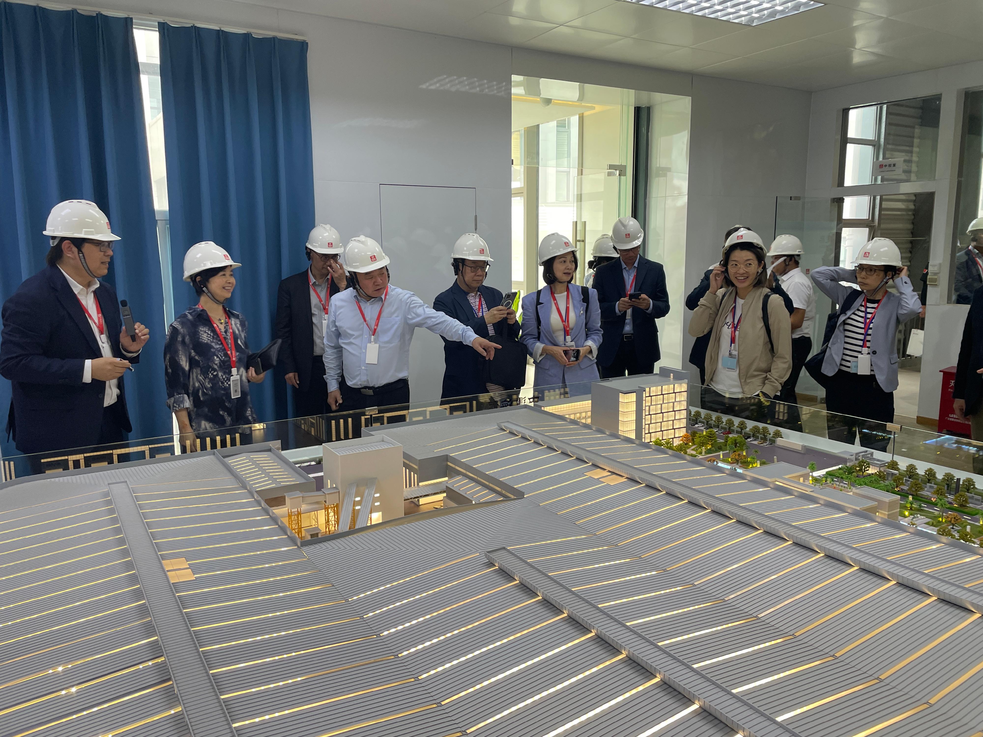 The Secretary for Housing and Chairman of the Hong Kong Housing Authority (HA), Ms Winnie Ho, and members of the HA Building Committee and Tender Committee, visited Foshan and Zhuhai today (July 19) to get an understanding of the latest situation regarding research and development and applications of innovative construction technologies in the Guangdong-Hong Kong-Macao Greater Bay Area cities. Photo shows Ms Ho (second left) and the Chairman of the Building Committee, Dr Johnnie Chan (fifth left), visiting the Guangdong Hailong Construction Technology Company Limited in Zhuhai.