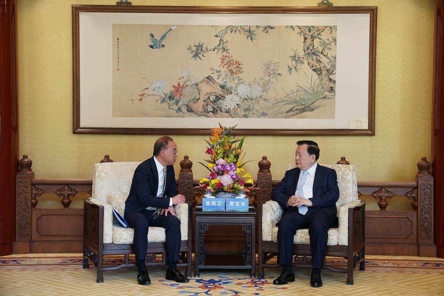 During his visit to Beijing, the Secretary for Constitutional and Mainland Affairs, Mr Erick Tsang Kwok-wai (left), is received by the Director of the Hong Kong and Macao Affairs Office of the State Council, Mr Xia Baolong (right).