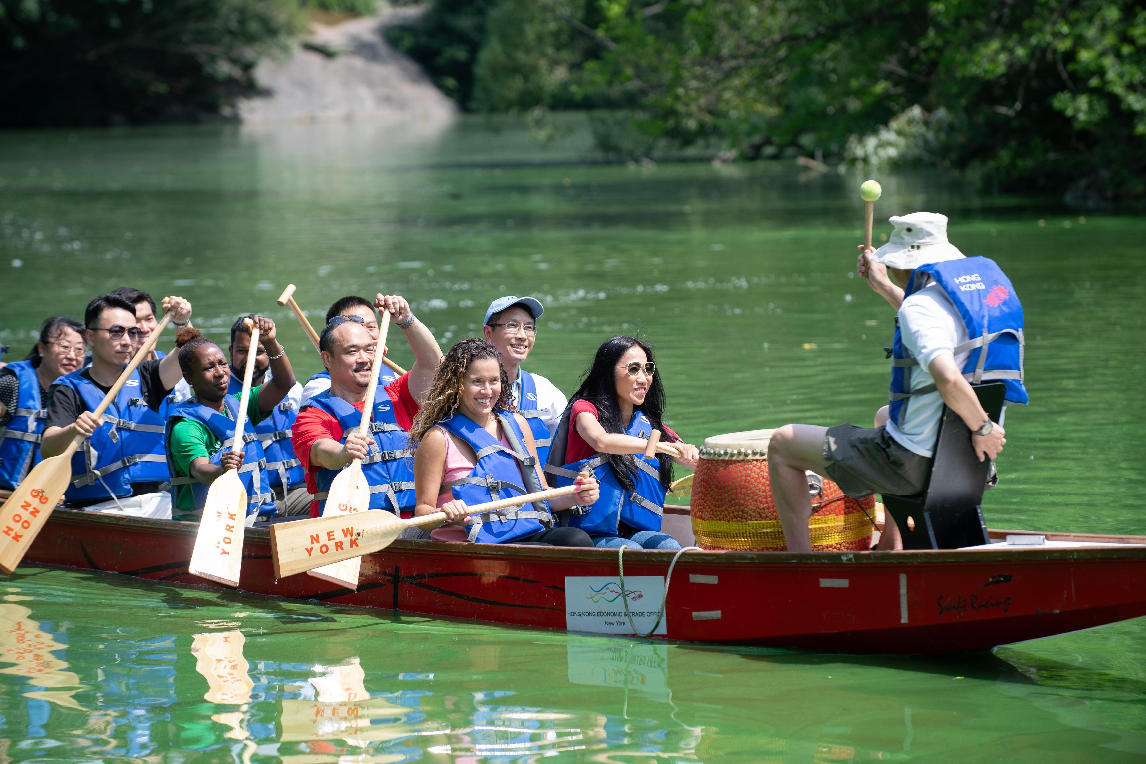 The Director of the Hong Kong Economic and Trade Office, New York, Ms Candy Nip (first row, first right), and other guests paddle a dragon boat in The Lake in New York’s Central Park on July 20, New York time.
