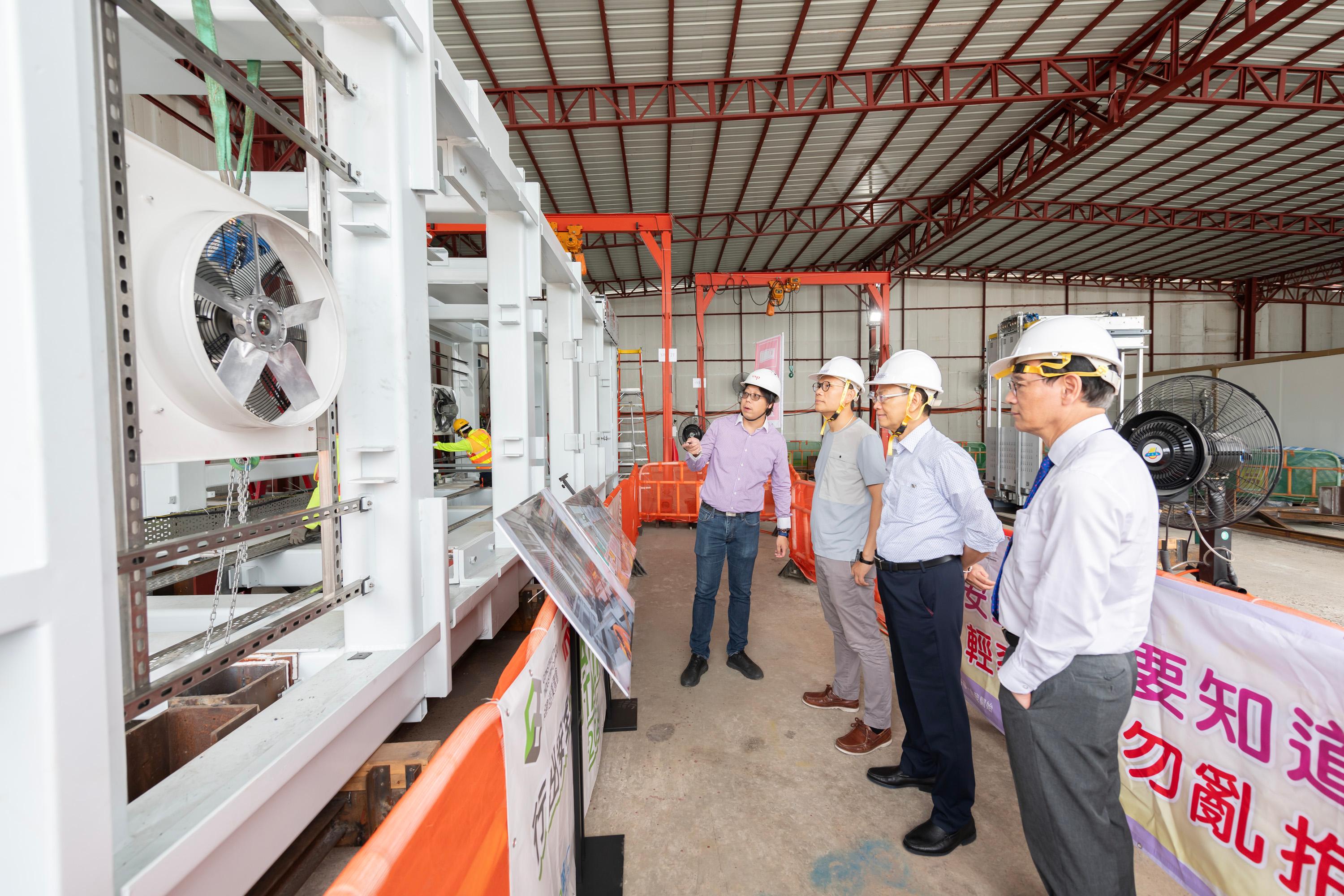 The Legislative Council (LegCo) Panel on Transport visited the Modular Integrated Construction (MiC) lift assembly yard under the Universal Accessibility Programme today (July 21) to learn about the Government's latest progress in building barrier-free facilities in public walkways. Photo shows LegCo Members visiting the production line of MiC lifts at the assembly yard.
