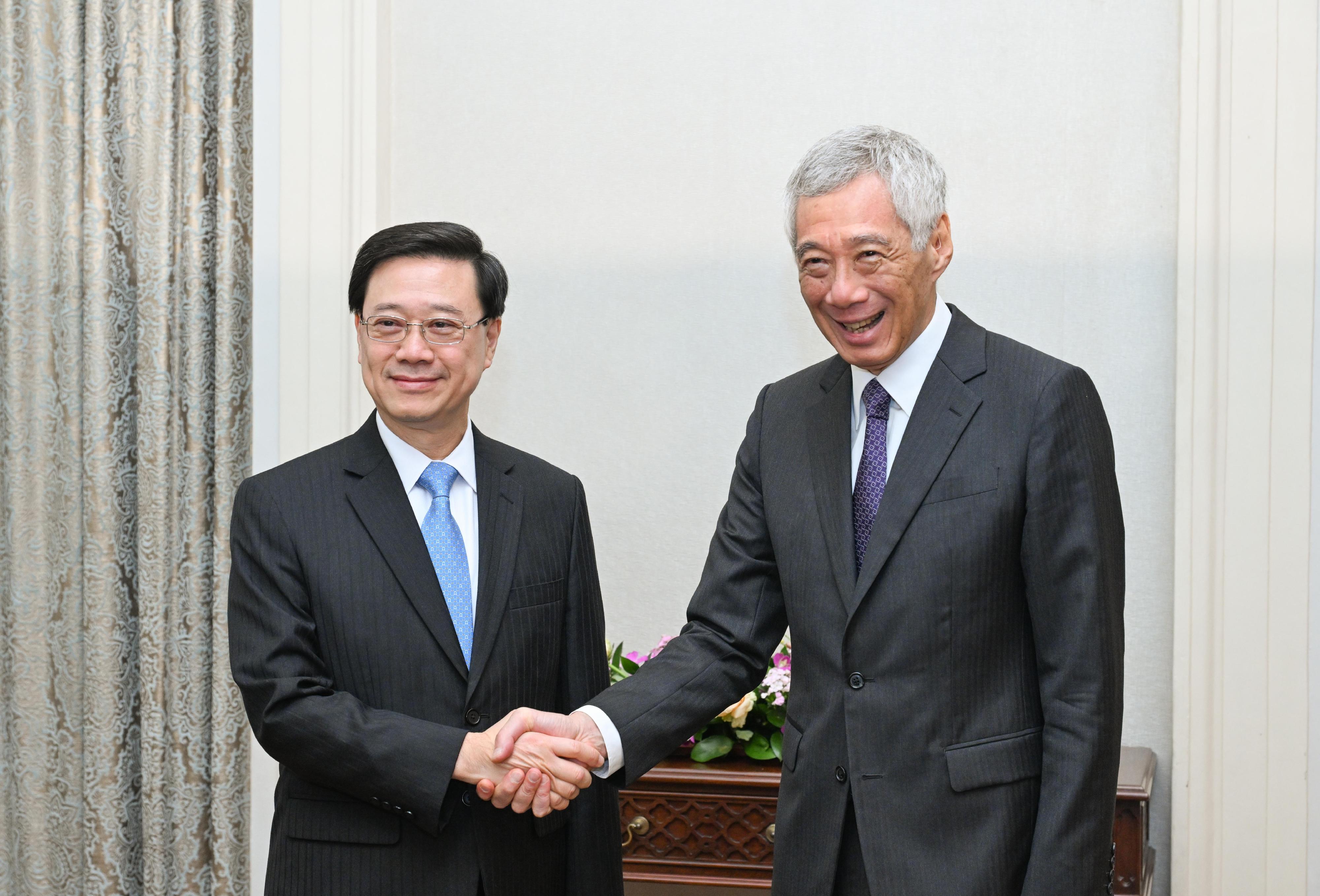 The Chief Executive, Mr John Lee (left), meets with the Prime Minister of Singapore, Mr Lee Hsien Loong (right), in Singapore today (July 24).