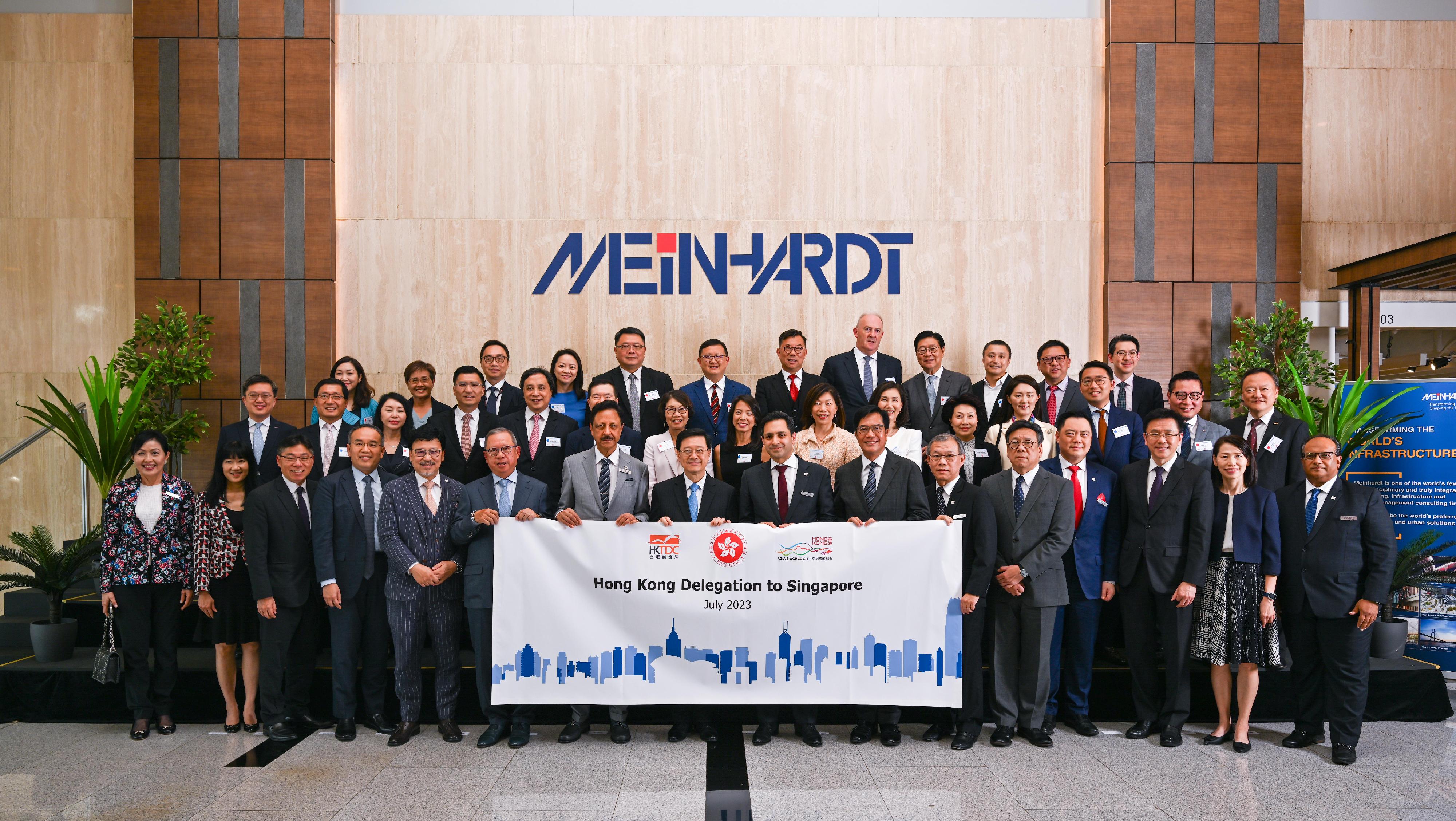 The Chief Executive, Mr John Lee, and a Hong Kong Special Administrative Region delegation visited Meinhardt Group in Singapore today (July 24). Photo shows Mr Lee (first row, eighth left); the Executive Chairman of Meinhardt Group, Dr Shahzad Nasim (first row, seventh left); the Deputy Financial Secretary, Mr Michael Wong (first row, seventh right); the Secretary for Financial Services and the Treasury, Mr Christopher Hui (first row, fourth left); the Secretary for Commerce and Economic Development, Mr Algernon Yau (first row, fifth right); the Secretary for Transport and Logistics, Mr Lam Sai-hung (first row, third left); the Secretary for Innovation, Technology and Industry, Professor Sun Dong (first row, third right); the Chairman of the Hong Kong Trade Development Council, Dr Peter Lam (first row, sixth left), and members of the delegation and representatives of the company.