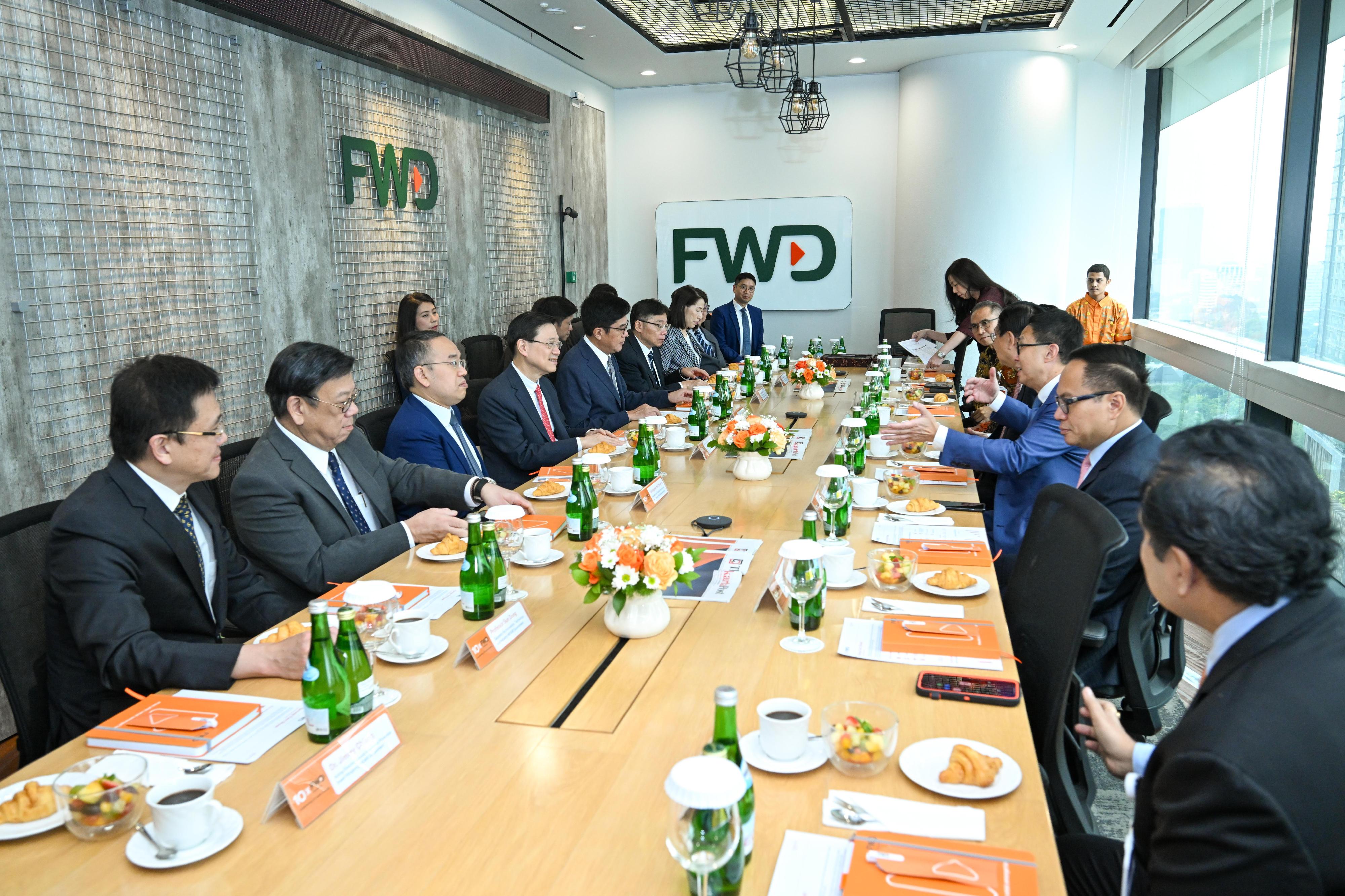 The Chief Executive, Mr John Lee, and a Hong Kong Special Administrative Region delegation visited the local office of a Hong Kong insurance company, FWD Group, in Jakarta, Indonesia today (July 26). Photo shows Mr Lee (fourth left); the Deputy Financial Secretary, Mr Michael Wong (fifth left); the Secretary for Financial Services and the Treasury, Mr Christopher Hui (third left); the Secretary for Commerce and Economic Development, Mr Algernon Yau (second left); and the Secretary for Transport and Logistics, Mr Lam Sai-hung (sixth left), meeting with the Chairman of Pacific Century Group, Mr Richard Li (third right), and representatives of the company.