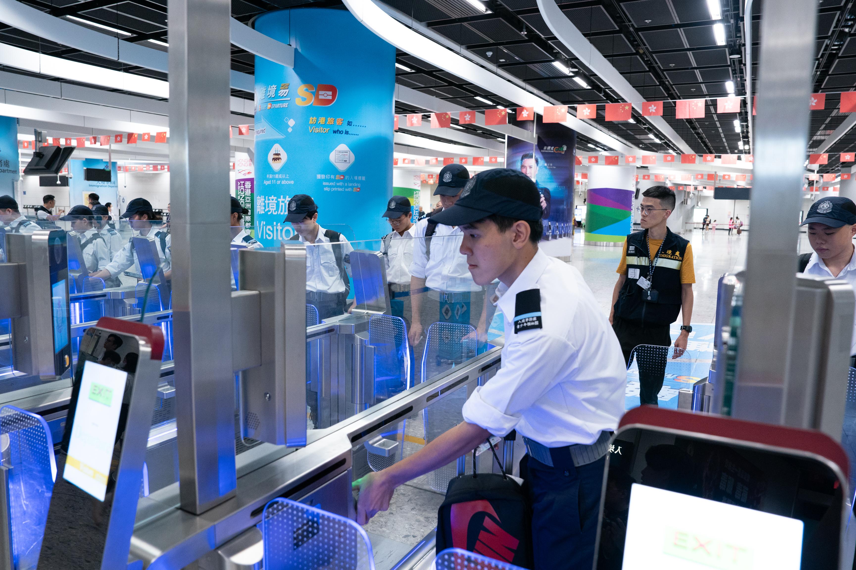 The Immigration Department Youth Leaders Corps (IDYL) organised a summer exchange tour to the Greater Bay Area from July 24 to 26, 2023. Photo shows an IDYL member using the e-Channel to perform automated immigration clearance at the Express Rail Link West Kowloon Control Point.