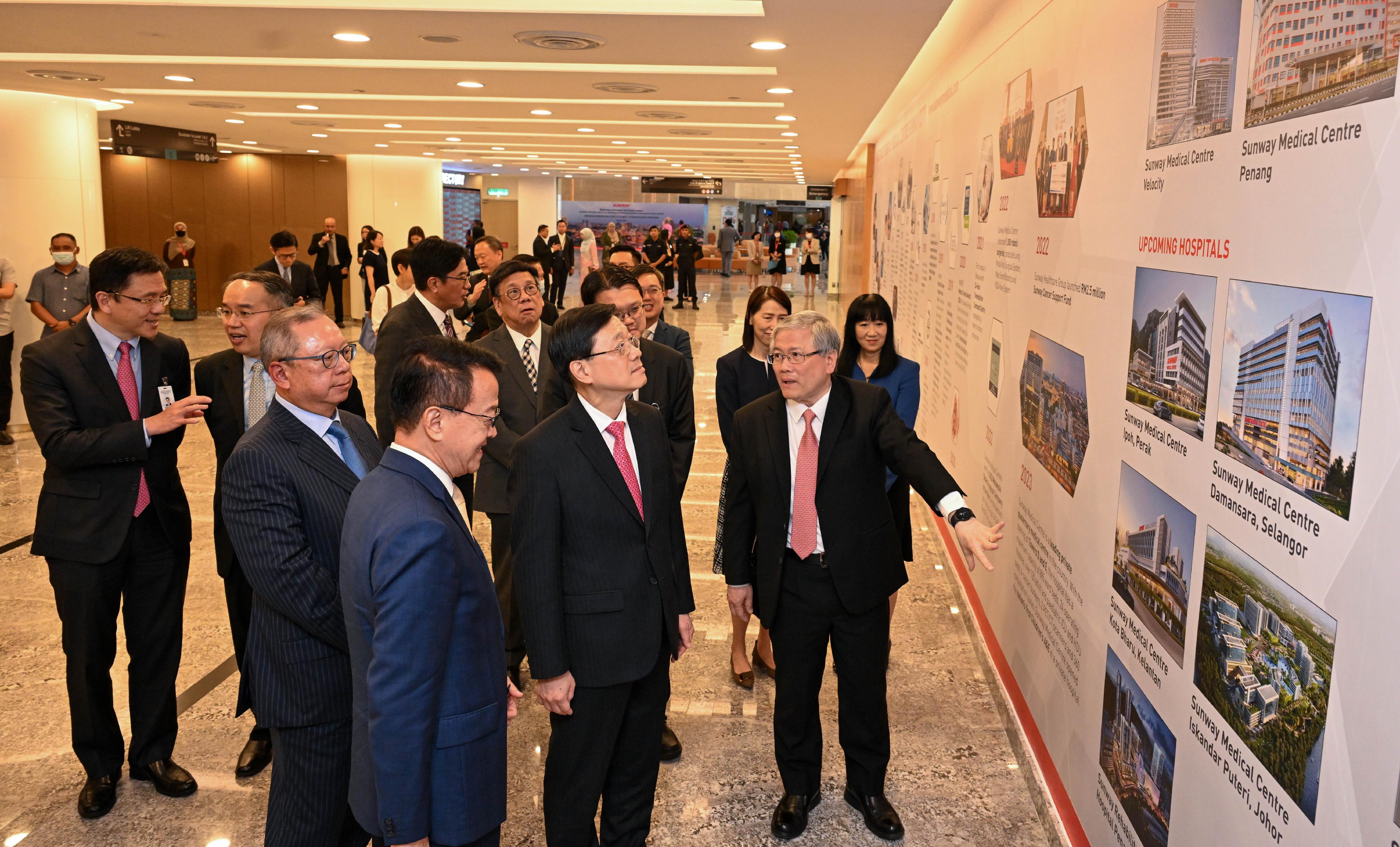 The Chief Executive, Mr John Lee, and the Hong Kong Special Administrative Region delegation visited Sunway Group in Kuala Lumpur, Malaysia, today (July 28). Photo shows Mr Lee (front row, second right) being briefed by a representative of the company.