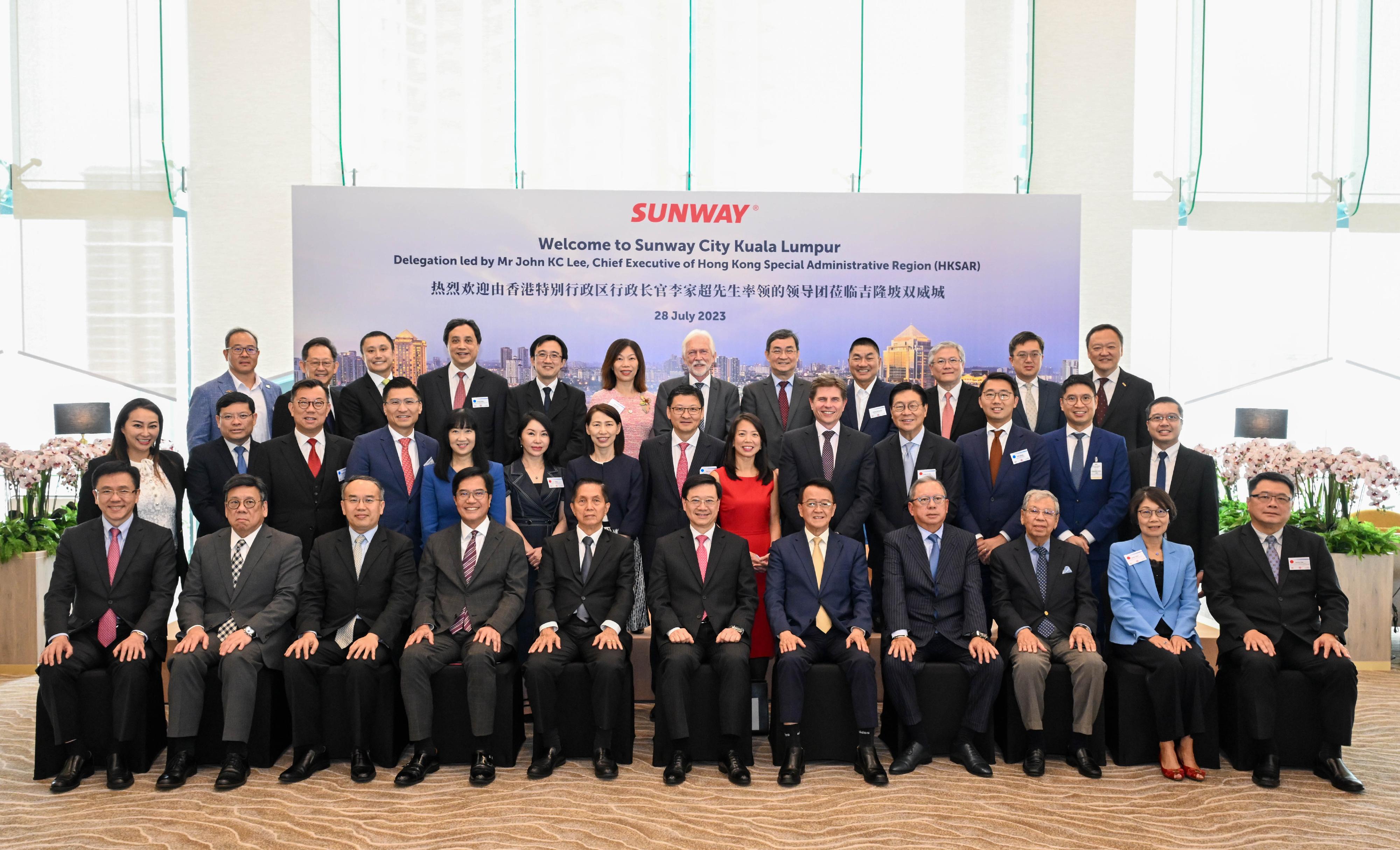 The Chief Executive, Mr John Lee, and the Hong Kong Special Administrative Region delegation visited Sunway Group in Kuala Lumpur, Malaysia, today (July 28). Photo shows Mr Lee (first row, centre); the Deputy Financial Secretary, Mr Michael Wong (first row, fourth left); the Secretary for Financial Services and the Treasury, Mr Christopher Hui (first row, third left); the Secretary for Commerce and Economic Development, Mr Algernon Yau (first row, second left); the Secretary for Innovation, Technology and Industry, Professor Sun Dong (first row, first left); the Founder and Chairman of Sunway Group, Dr Jeffrey Cheah (first row, fifth right); the Chairman of the Hong Kong Trade Development Council, Dr Peter Lam (first row, fourth right), and other members of the delegation and representatives of the company.