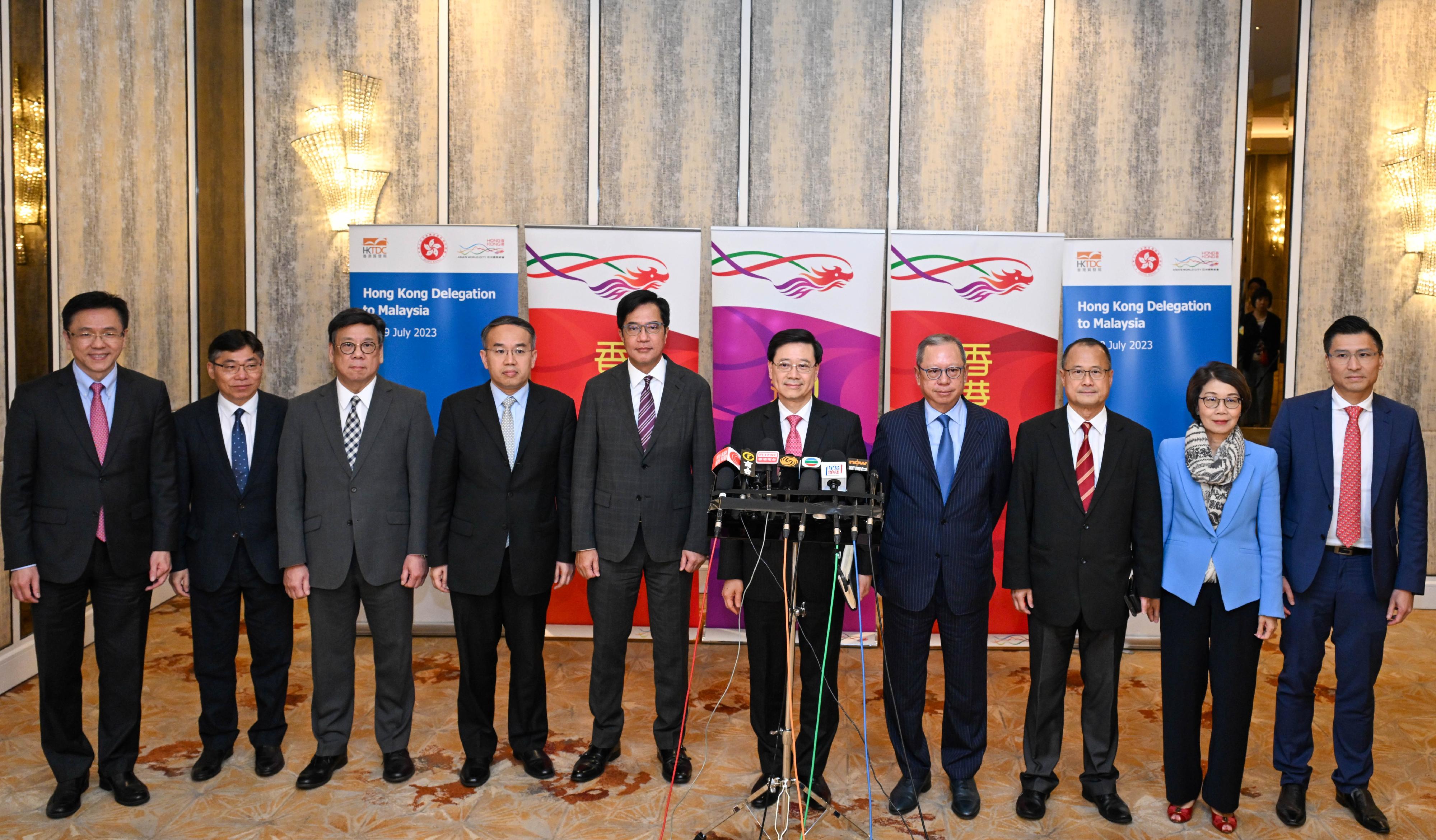 The Chief Executive, Mr John Lee (fifth right), together with the Deputy Financial Secretary, Mr Michael Wong (fifth left); the Secretary for Financial Services and the Treasury, Mr Christopher Hui (fourth left); the Secretary for Commerce and Economic Development, Mr Algernon Yau (third left); the Secretary for Transport and Logistics, Mr Lam Sai-hung (second left); the Secretary for Innovation, Technology and Industry, Professor Sun Dong (first left); the Chairman of the Hong Kong Trade Development Council, Dr Peter Lam (fourth right); the Chairman of the Chinese General Chamber of Commerce, Dr Jonathan Choi (third right); the Chairman of the Hong Kong General Chamber of Commerce, Mrs Betty Yuen (second right); and the Member of the Legislative Council for the technology and innovation functional constituency, Mr Duncan Chiu (first right), meet the media in Kuala Lumpur, Malaysia, today (July 28).
