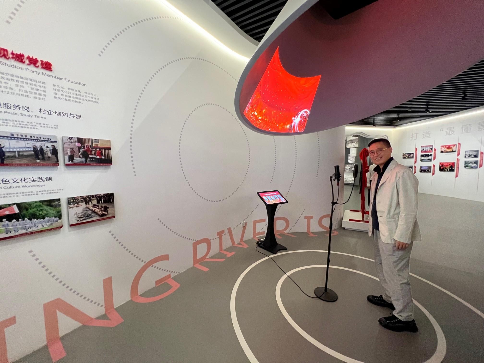 The Secretary for Culture, Sports and Tourism, Mr Kevin Yeung, today (August 2) visited Hengdian World Studios in Dongyang, Zhejiang Province, to get a grasp of the studio's development and opportunities arising for film industry workers. Photo shows Mr Yeung checking a voice-over device in an exhibition centre in Hengdian World Studios.