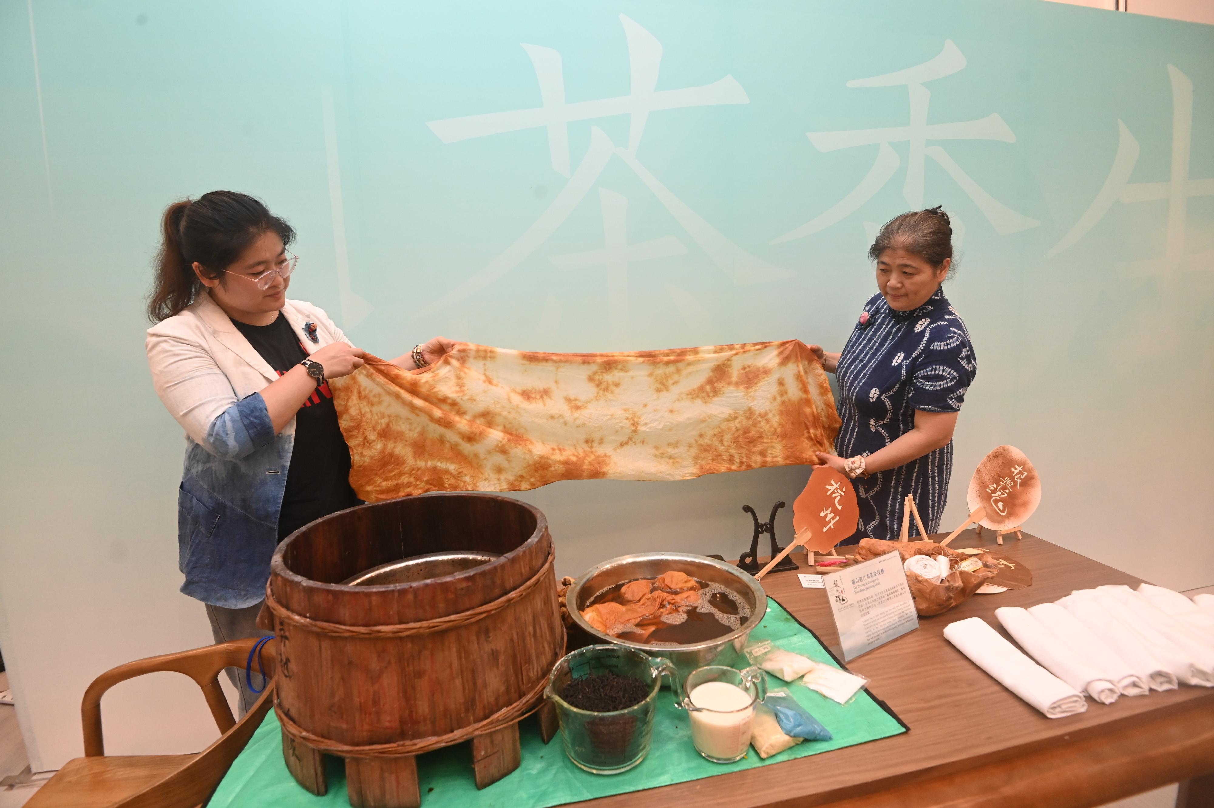 The opening ceremony for the "Genesis and Spirit - Tea for Harmony · Yaji Cultural Salon: Exhibition of the Tea Culture of Zhejiang" was held today (August 4) at the Hong Kong Central Library. Photo shows the demonstration of Zhejiang Provincial intangible cultural heritage item, tea dyeing technique of Xiaoshan guojiang cloth. 

