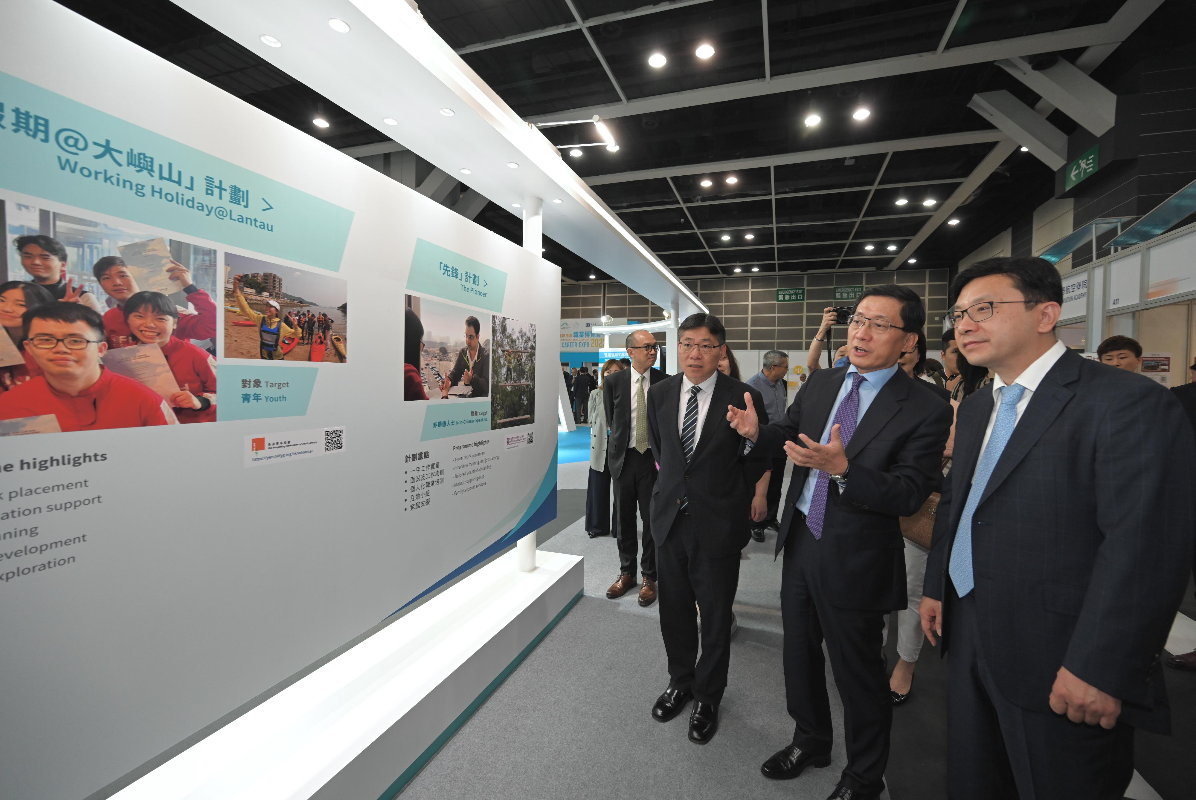 The Secretary for Transport and Logistics, Mr Lam Sai-hung, and the Secretary for Labour and Welfare, Mr Chris Sun, today (August 4) officiated at the opening ceremony of the Hong Kong International Airport Career Expo 2023 jointly launched by the Airport Authority Hong Kong and the Labour Department. Photo shows the Chief Executive Officer of the Airport Authority Hong Kong, Mr Fred Lam (centre), introducing the booth of Hong Kong International Airport to Mr Lam (left) and Mr Sun (right).