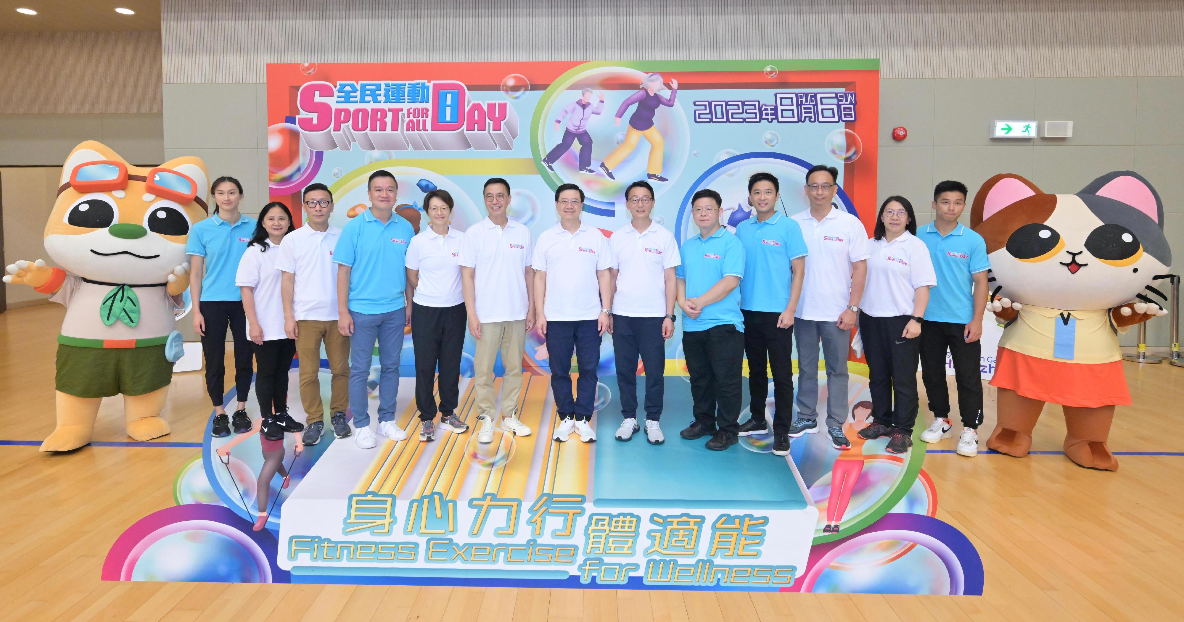 The Chief Executive, Mr John Lee, attended the Sport For All Day 2023 held by the Leisure and Cultural Services Department at the Sham Shui Po Sports Centre and took part in sports fun games this afternoon (August 6). Photo shows Mr Lee (centre); the Secretary for Culture, Sports and Tourism, Mr Kevin Yeung (sixth left); the Director of Leisure and Cultural Services, Mr Vincent Liu (sixth right); the Deputy Director of Leisure and Cultural Services (Leisure Services), Miss Winnie Chui (fifth left); the Chairman of the Sham Shui Po District Council, Mr Chum Tak-shing (fifth right); the Chairman of the Community Sports Committee (CSC), Professor Patrick Yung (fourth left); the Vice Chairman of the CSC, Mr Eric Fok (fourth right); the District Officer (Sham Shui Po), Mr Paul Wong (third left); the Assistant Director of Leisure and Cultural Services (Leisure Services)1, Mr Henry Wong (third right); the Assistant Director of Leisure and Cultural Services (Leisure Services)3, Ms Fung Miu-ling (second right); the Acting Assistant Director of Leisure and Cultural Services (Leisure Services)2, Ms Alice Kong (second left); swimming athlete Tam Hoi-lam (first left) and wushu athlete Lau Tsz-hong (first right) in front of a 3D display board of the Sport For All Day 2023.
