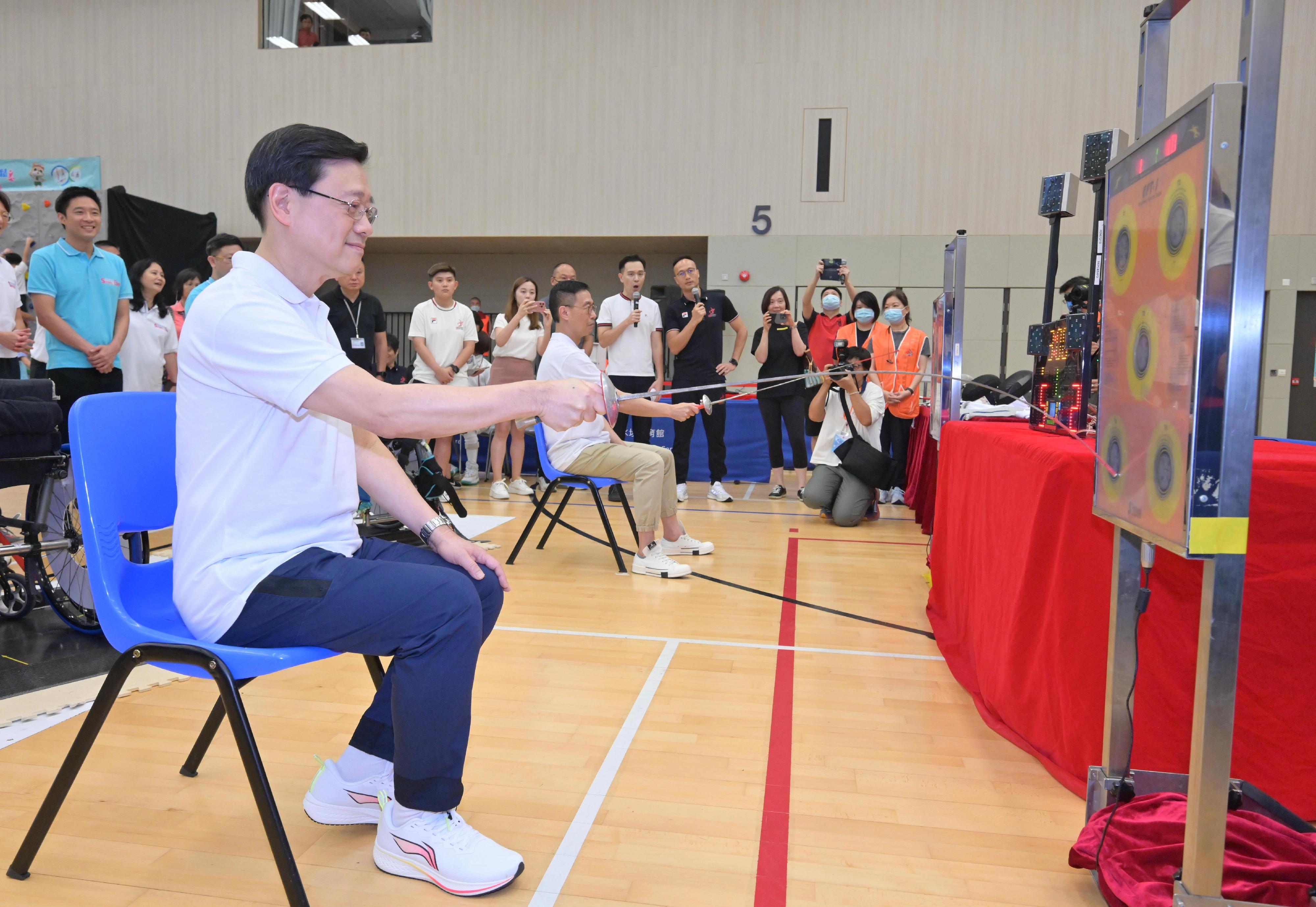 The Chief Executive, Mr John Lee, attended the Sport For All Day 2023 held by the Leisure and Cultural Services Department at the Sham Shui Po Sports Centre and took part in sports fun games this afternoon (August 6). Photo shows Mr Lee (left) and the Secretary for Culture, Sports and Tourism, Mr Kevin Yeung (right), joining a fencing play-in session.