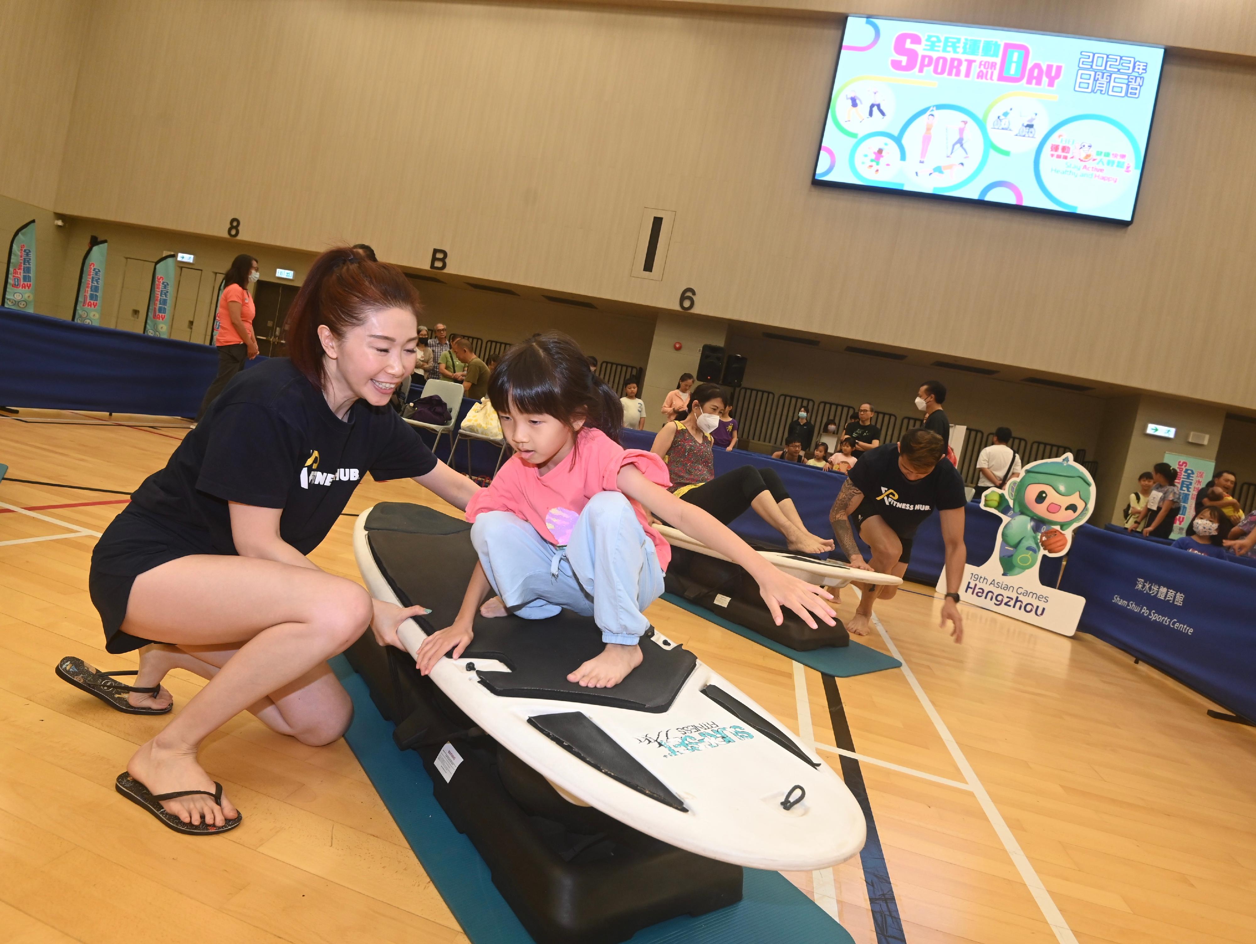 The Sport For All Day 2023 was held by the Leisure and Cultural Services Department today (August 6) with free recreation and sports programmes at designated sports centres in 18 districts for the public to join. Photo shows members of the public taking part in surfset play-in session.