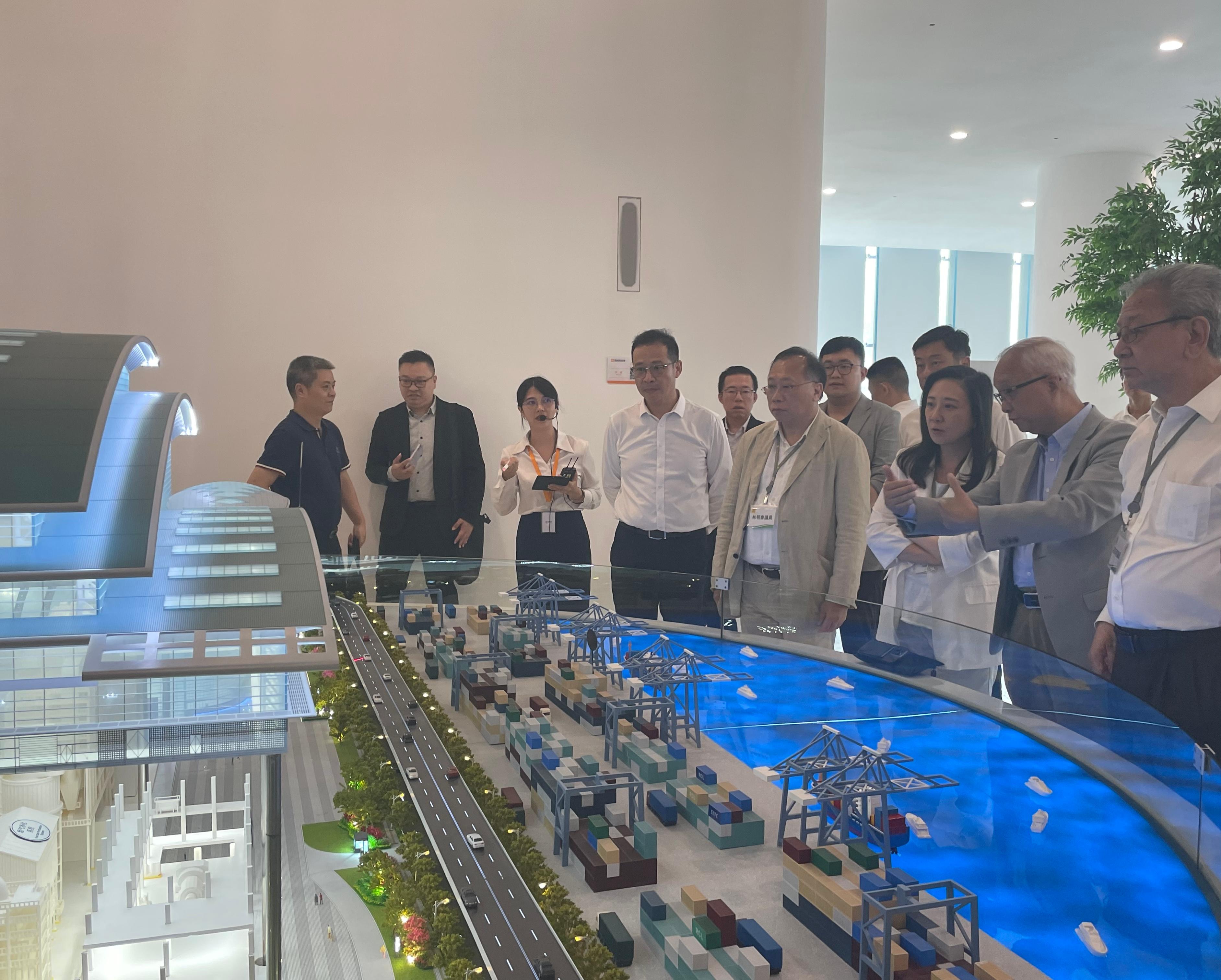 The Secretary for Environment and Ecology, Mr Tse Chin-wan, together with the Legislative Council Panel on Environmental Affairs, today (August 9) visited the Nanshan Energy Eco-Park in Shenzhen in the afternoon. Photo shows Mr Tse (seocnd right), and the delegation of the Legislative Council Panel on Environmental Affairs, receiving a briefing from a representative on the operation of the Park.