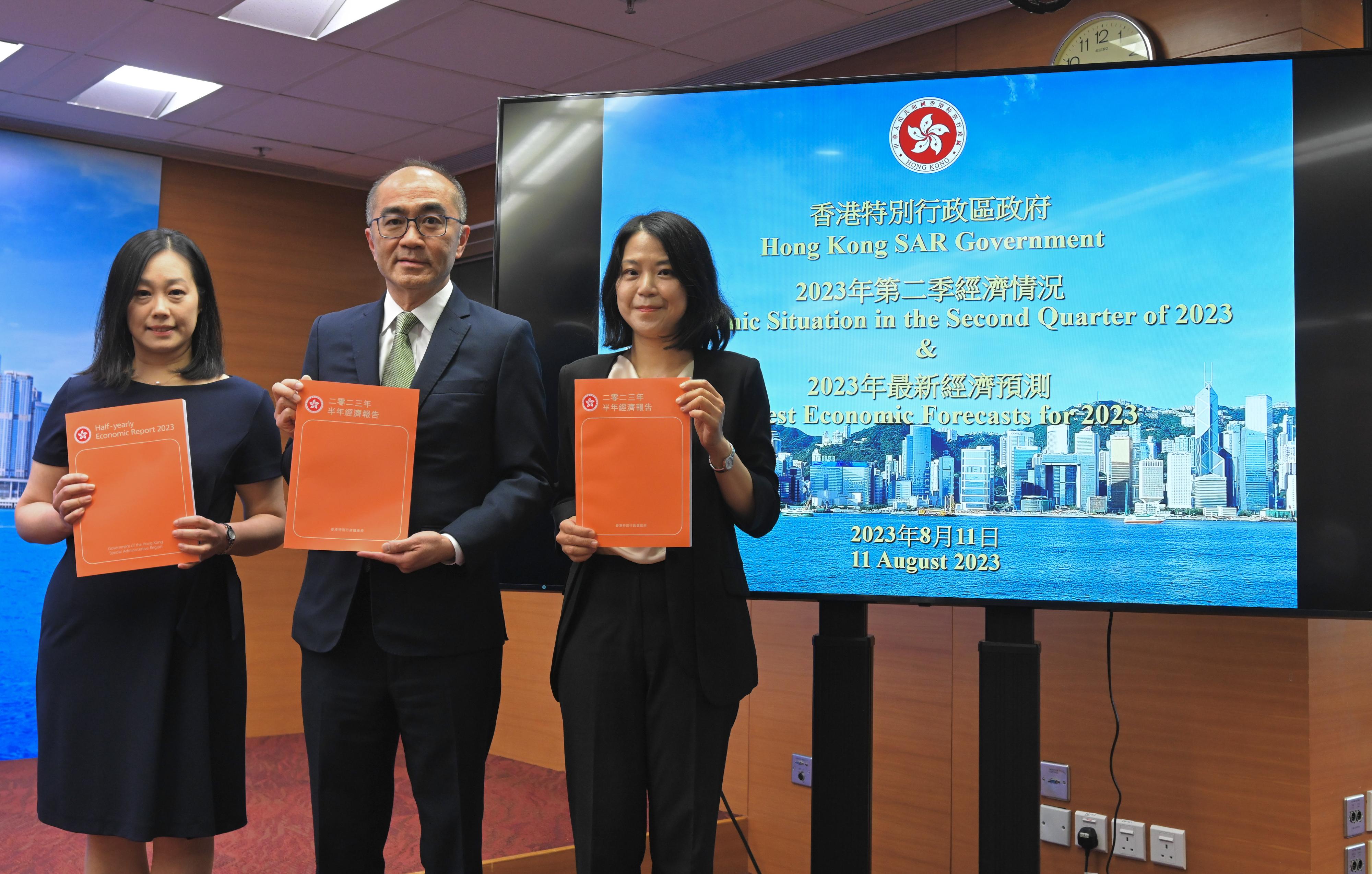 The Government Economist, Mr Adolph Leung (centre), presents the Half-yearly Economic Report 2023 at a press conference today (August 11). Also present are Principal Economist Ms Joyce Cheung (left) and Assistant Commissioner for Census and Statistics Ms Edith Chan (right).