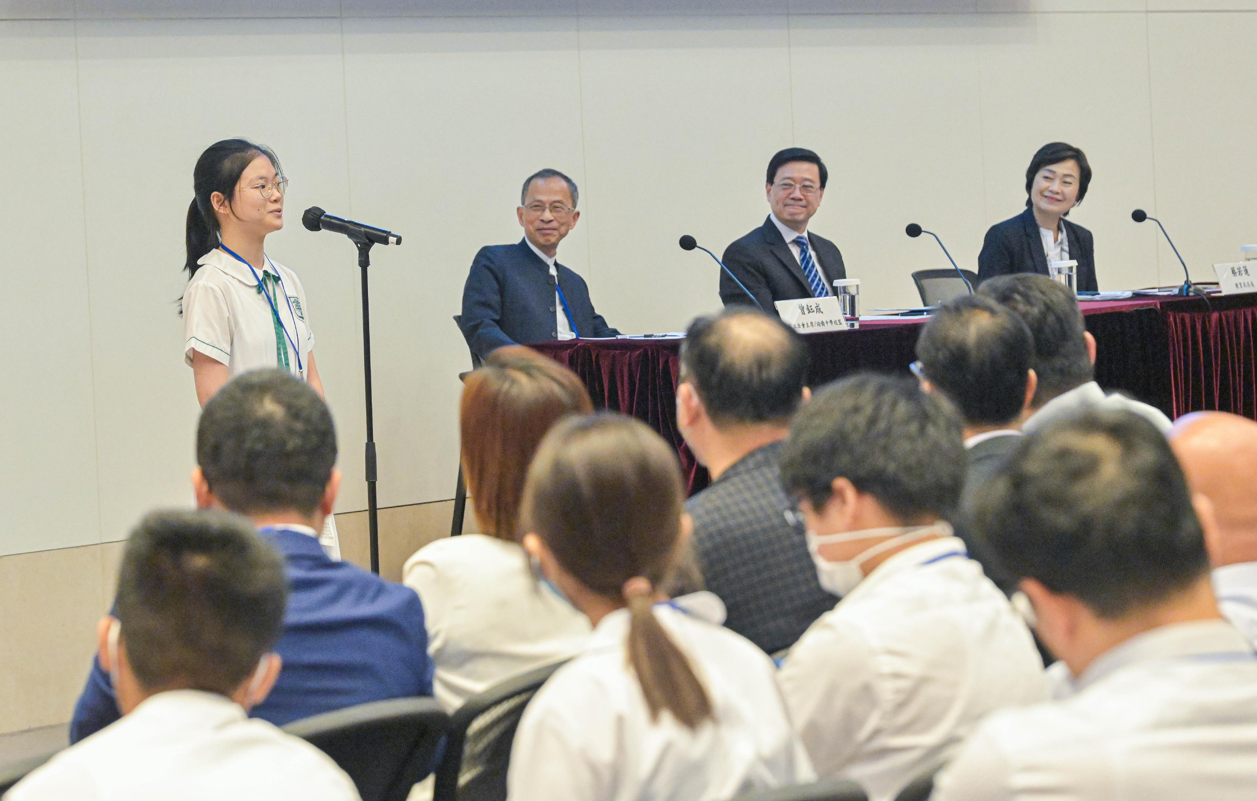 The Government of the Hong Kong Special Administrative Region today (August 11) held a sharing session on the "Important spirit of President Xi Jinping's reply letter to Hong Kong students" at the Central Government Offices. Photo shows the Chief Executive, Mr John Lee (second right); the Secretary for Education, Dr Choi Yuk-lin (first right); and the supervisor of Pui Kiu Middle School, Mr Jasper Tsang (second left), listening to the sharing by a student of Pui Kiu Middle School.