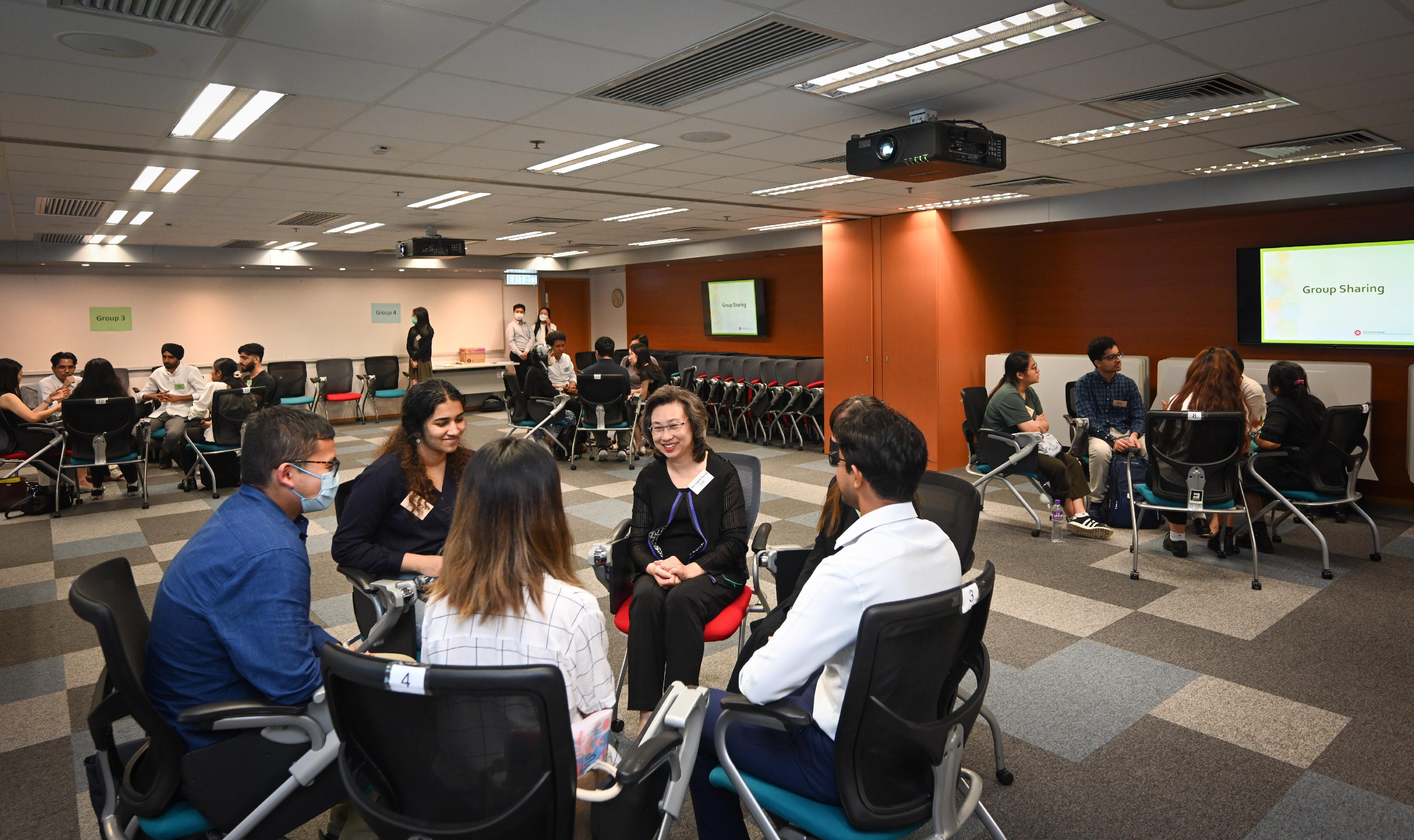 The Secretary for the Civil Service, Mrs Ingrid Yeung, today (August 17) attended a sharing session on the 2023 Internship Programme for Non-ethnic Chinese Students. Photo shows Mrs Yeung (third left) chatting with interns to learn about their internship experiences and takeaways.