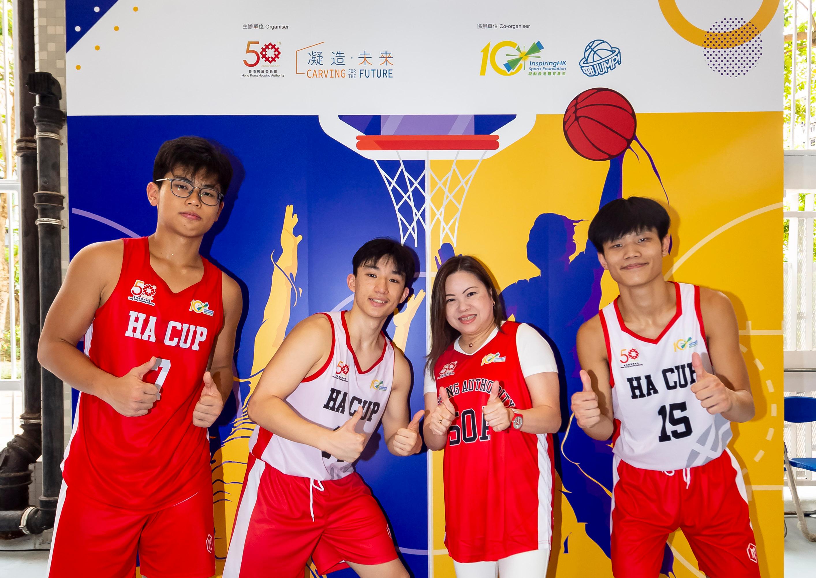香港房屋委員為慶祝成立50周年而舉辦的「房委會盃三人籃球挑戰賽」今日（八月二十日）進行決賽。圖示房屋局常任秘書長羅淑佩（右二）與年青球員。