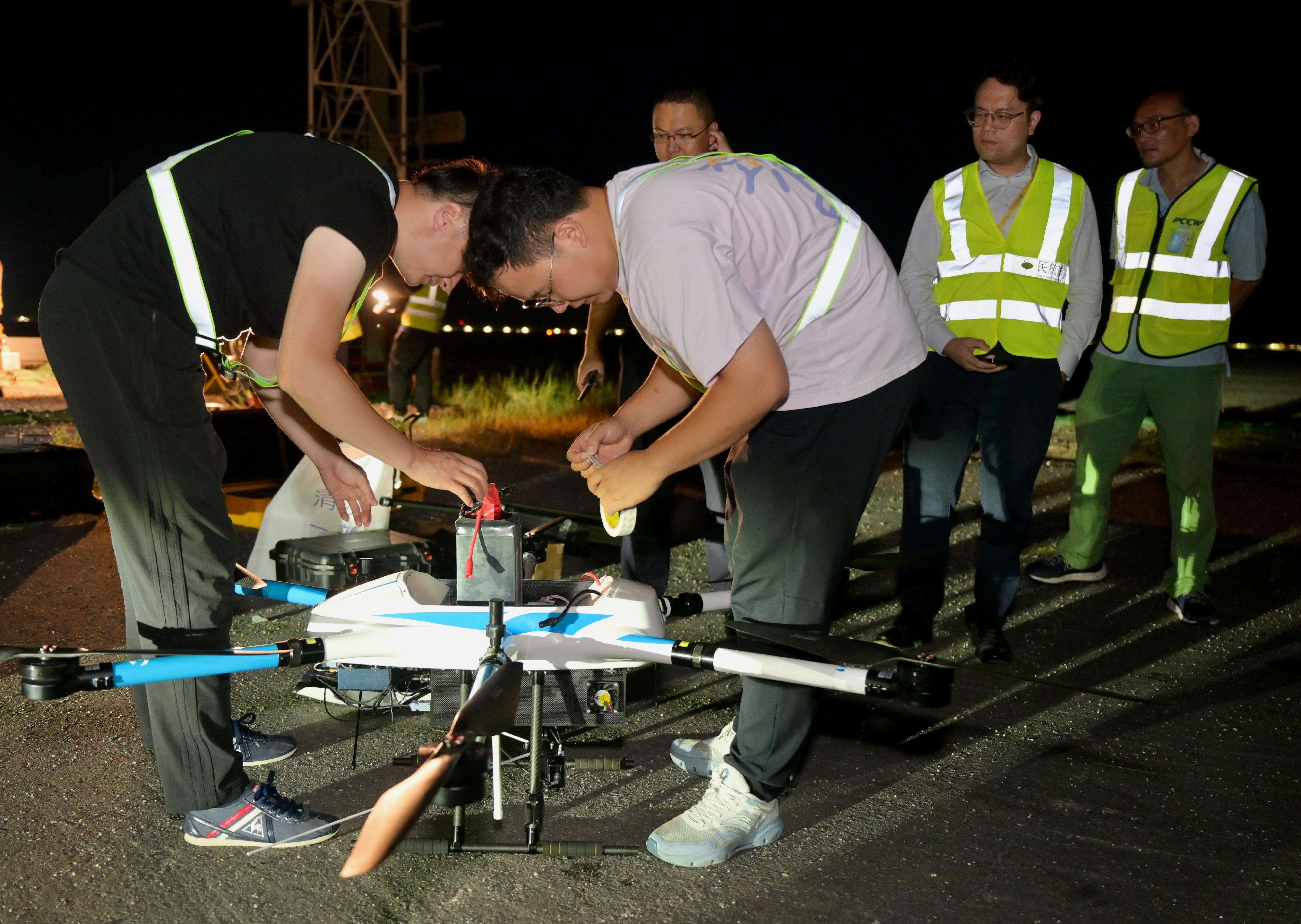 The Civil Aviation Department (CAD) today (August 20) conducted a trial flight inspection by small unmanned aircraft at Hong Kong International Airport. Photo shows experts from the CAD and the Civil Aviation Administration of China Flight Inspection Center, and relevant technical personnel preparing for the trial.