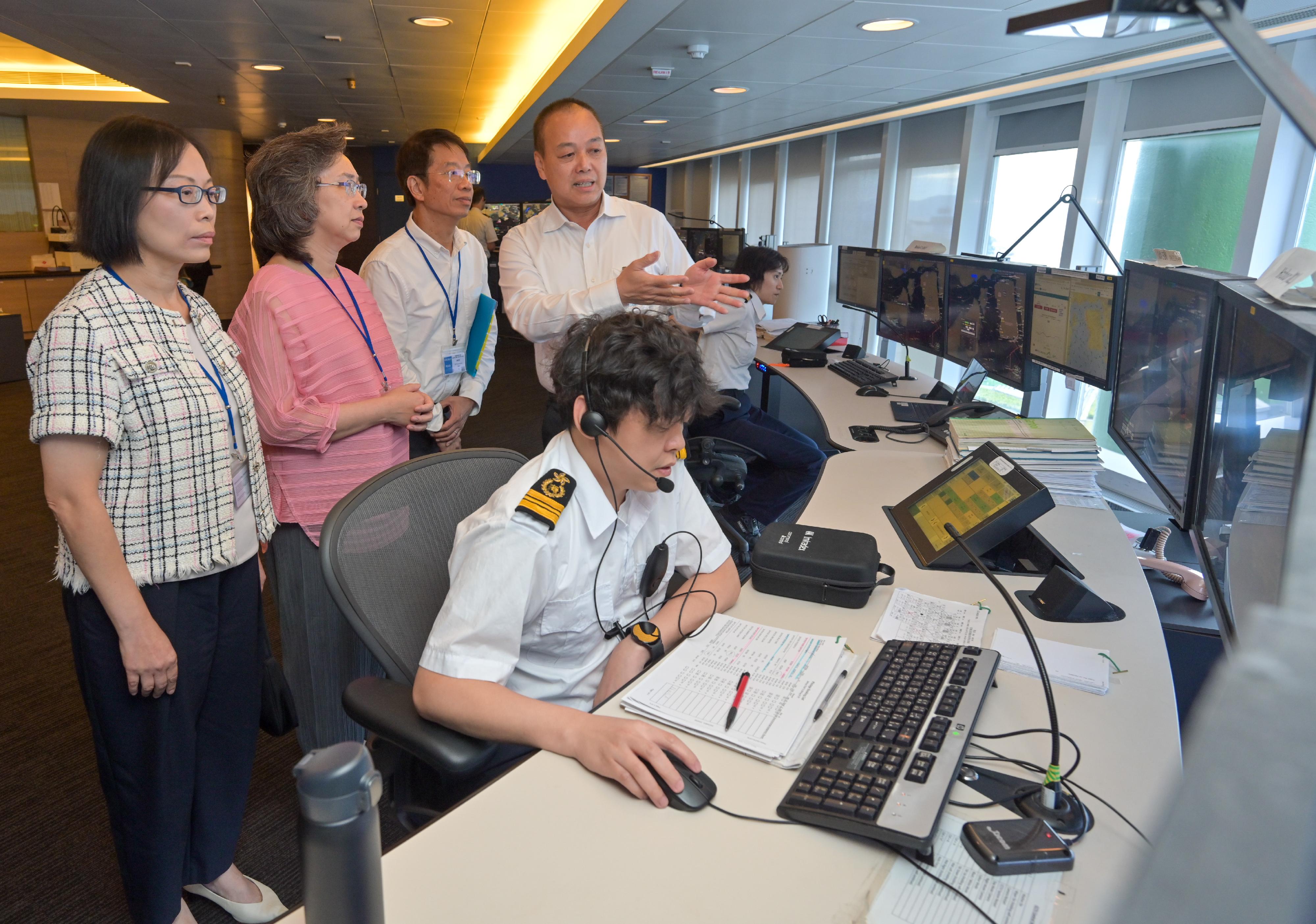 The Secretary for the Civil Service, Mrs Ingrid Yeung, visited the Marine Department today (August 24). Photo shows Mrs Yeung (second left) being briefed on the work of the Vessel Traffic Centre by the Assistant Director of Marine (Port Control), Mr Lai Chi-tung (fourth left). Looking on are the Permanent Secretary for the Civil Service, Mr Clement Leung (third left), and the Director of Marine, Ms Carol Yuen (first left).