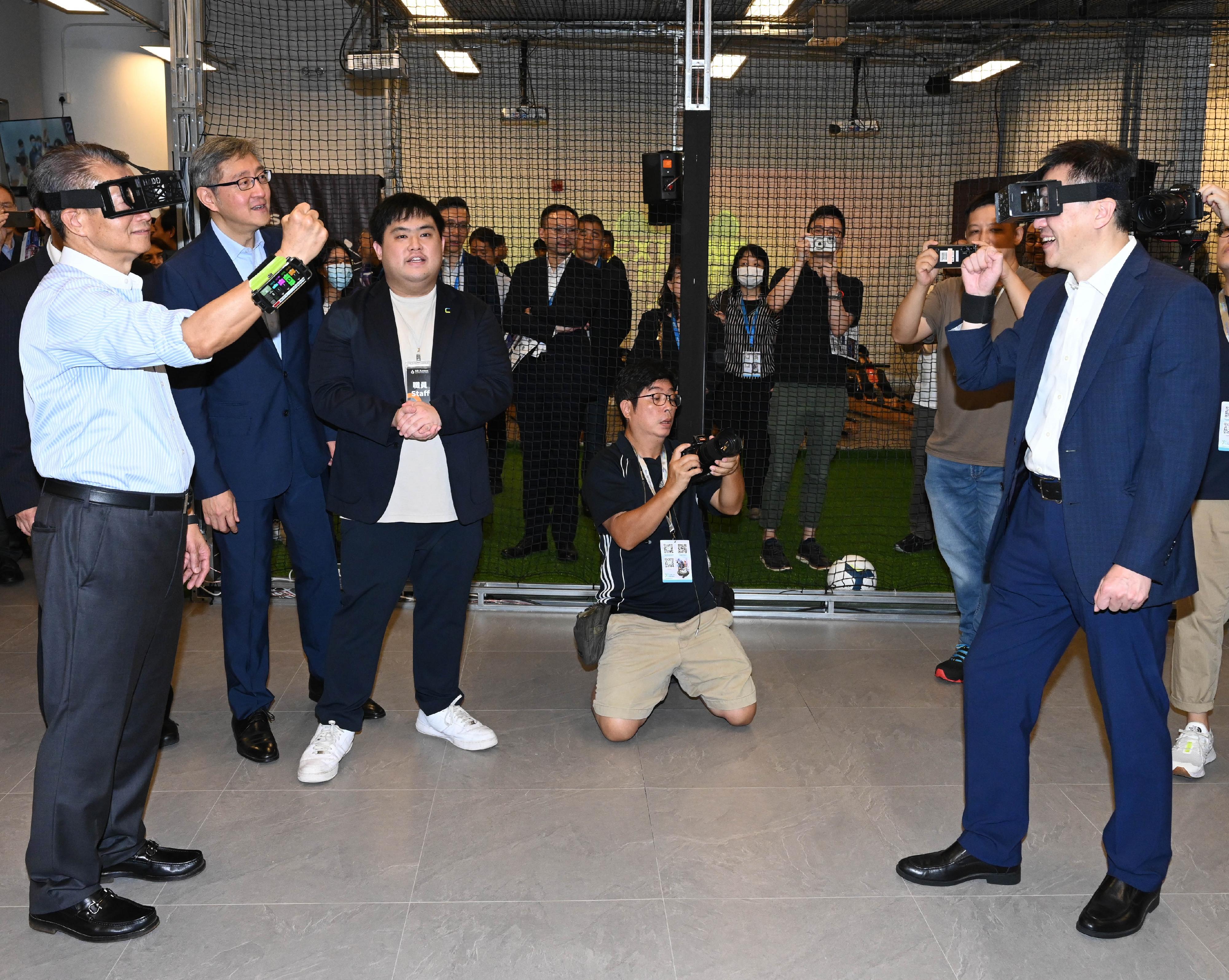 The Financial Secretary, Mr Paul Chan, attended the Digital Entertainment Leadership Forum 2023 today (August 25). Photo shows Mr Chan (first left) and the Secretary for Innovation, Technology and Industry, Professor Sun Dong (first right), experiencing augmented reality gaming. 