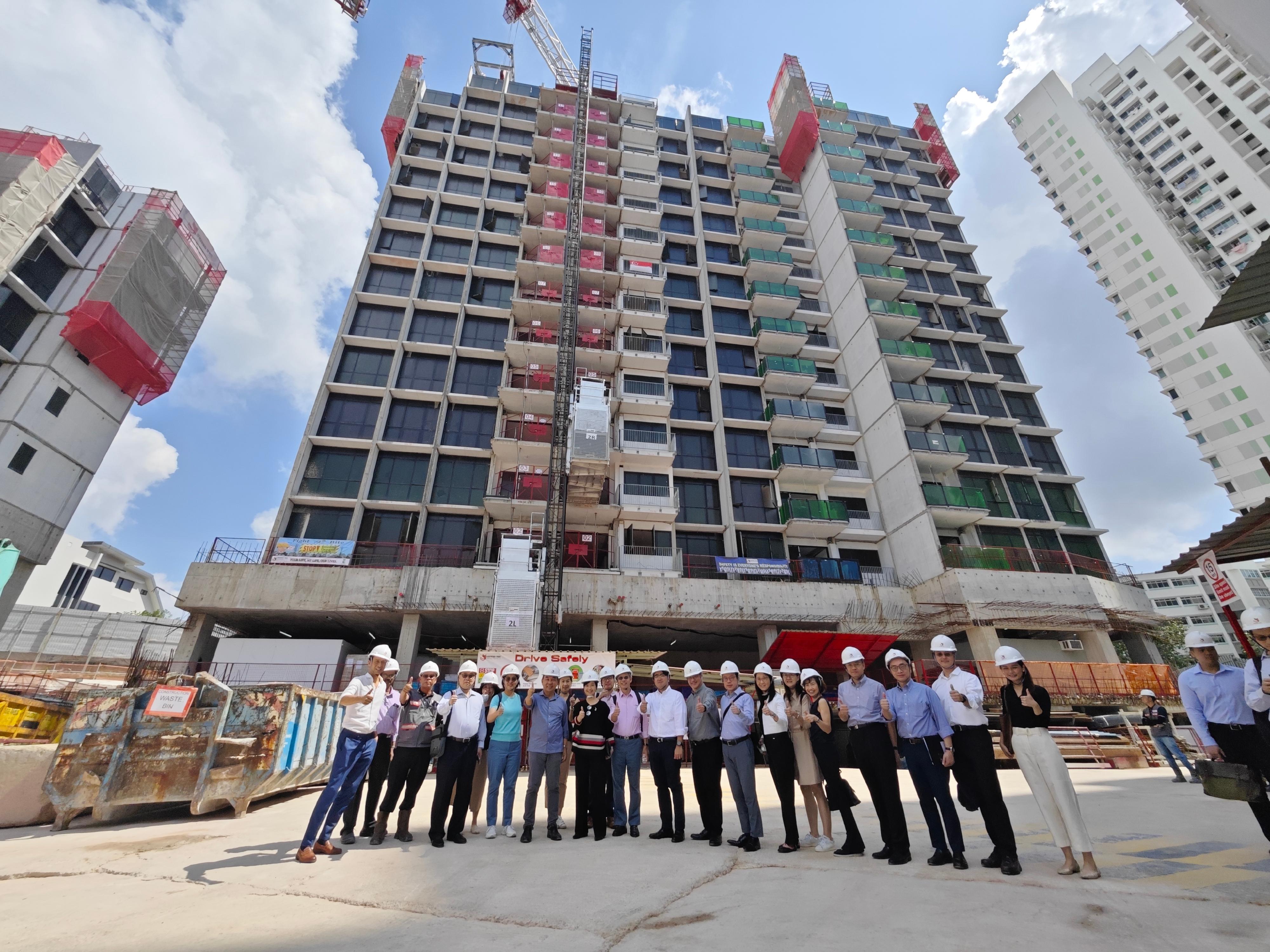 The Secretary for Housing, Ms Winnie Ho, was on the third day of her visit to Singapore yesterday (August 24). Photo shows Ms Ho (ninth left) visiting a project site of a construction company in Singapore to inspect the application of Modular Integrated Construction (MiC) (known as Prefabricated Prefinished Volumetric Construction (PPVC) in Singapore) in the project yesterday.