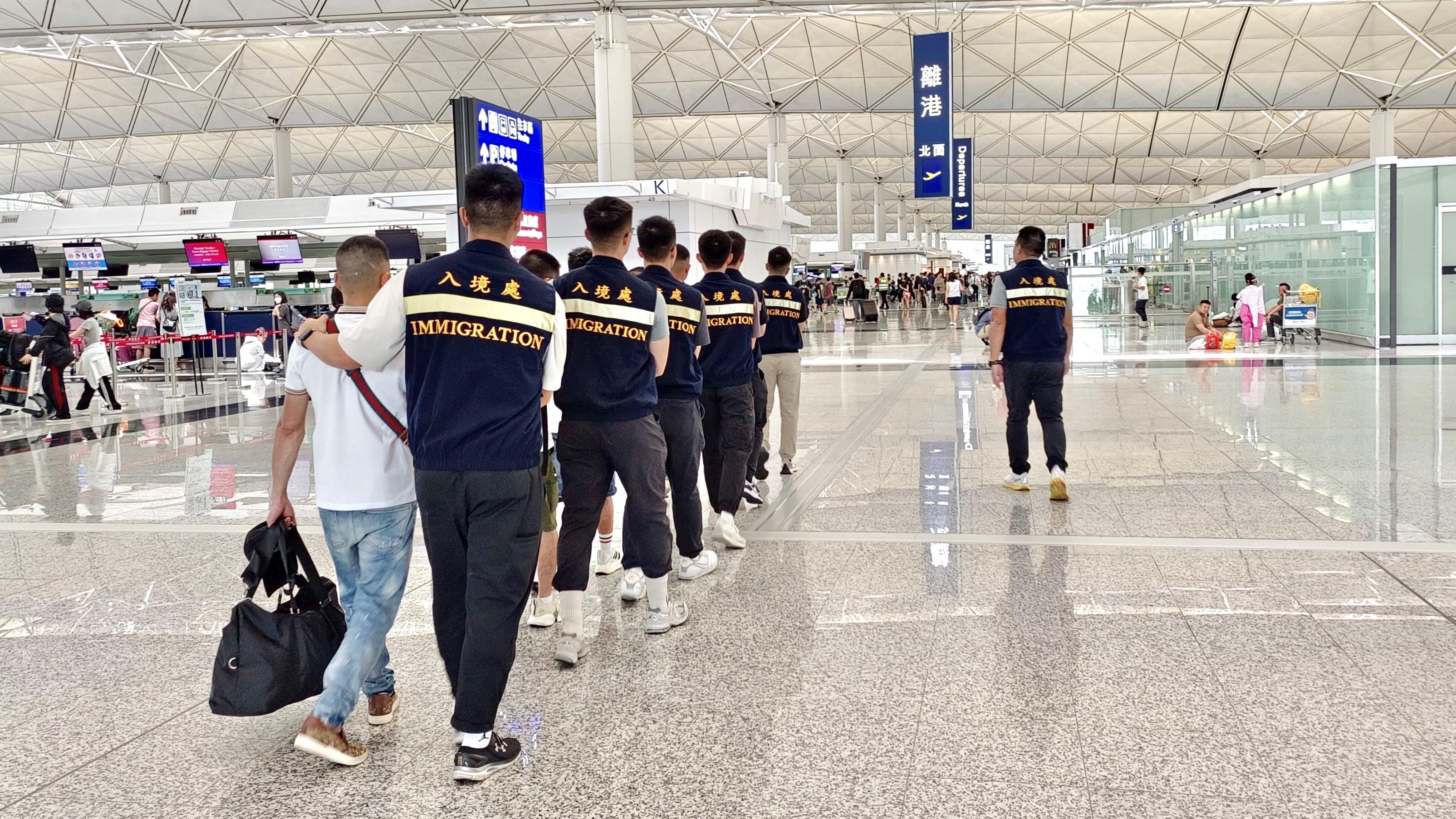 The Immigration Department (ImmD) carried out a repatriation operation today (August 25). A total of 30 Vietnamese illegal immigrants were repatriated to Vietnam. Photo shows removees being escorted by ImmD officers to depart from Hong Kong.