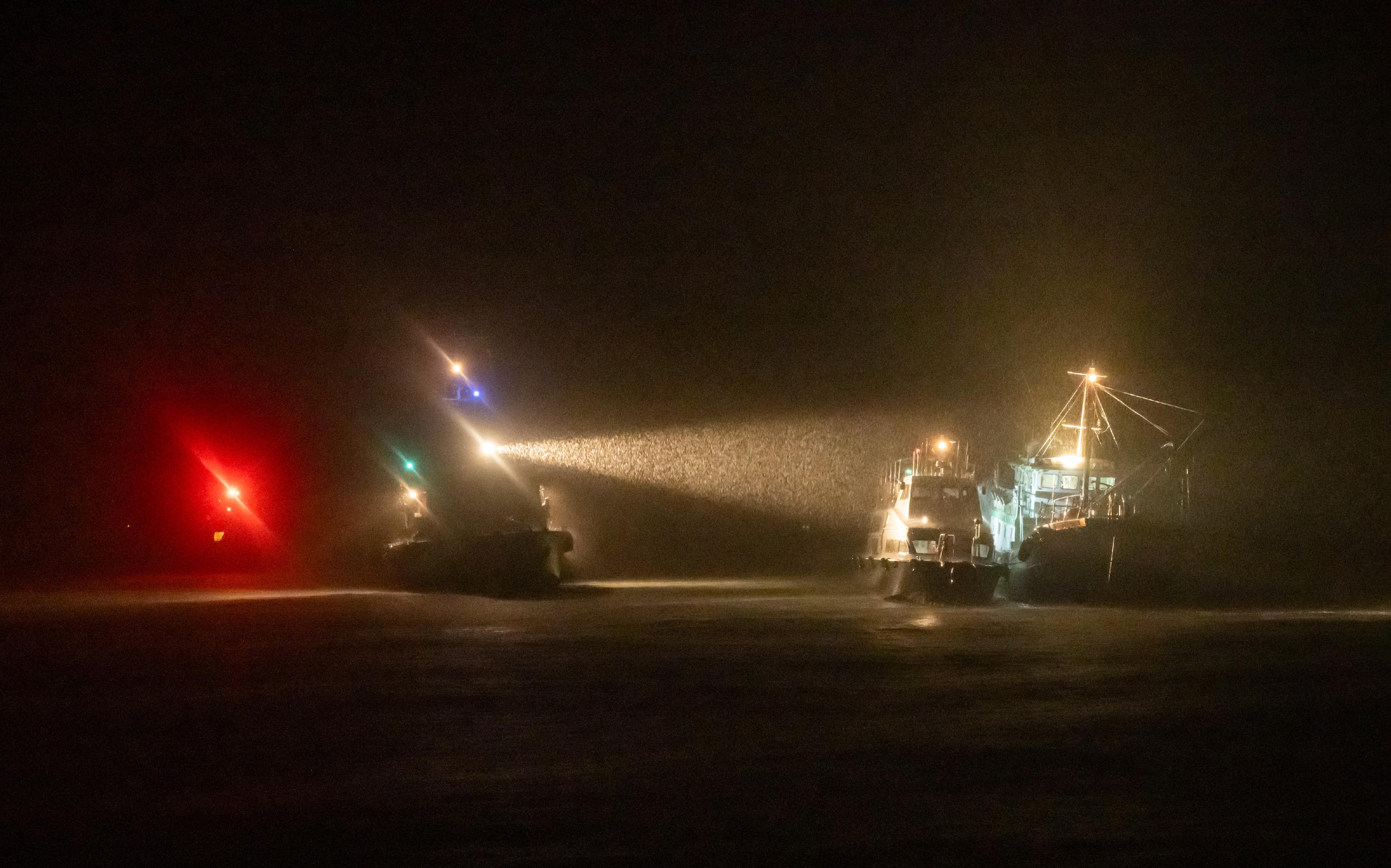 The Marine Department together with the Hong Kong Police Force and the Agriculture, Fisheries and Conservation Department conducted a joint operation against the improper use of bright light for fishing and illegal fishing activities in the southern waters of Hong Kong on September 7. Photo shows vessels of the three enforcement departments approaching a fishing vessel for inspection in the joint operation.