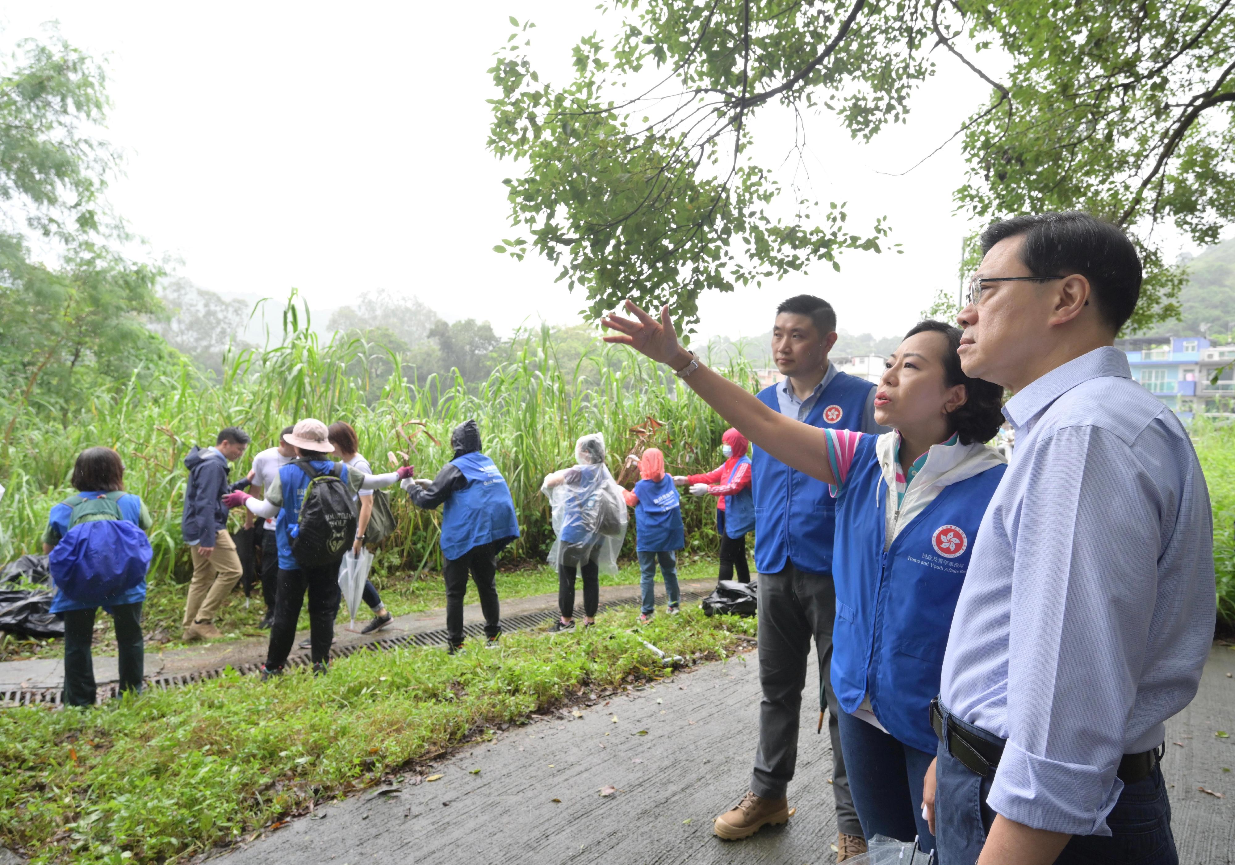 The Chief Executive, Mr John Lee (first right), accompanied by the Secretary for Home and Youth Affairs, Miss Alice Mak (second right), and the District Officer (North), Mr Derek Lai (third right), visits Ma Mei Ha Tsuen in Fanling to inspect the relief work in the wake of the torrential rain today (September 9).