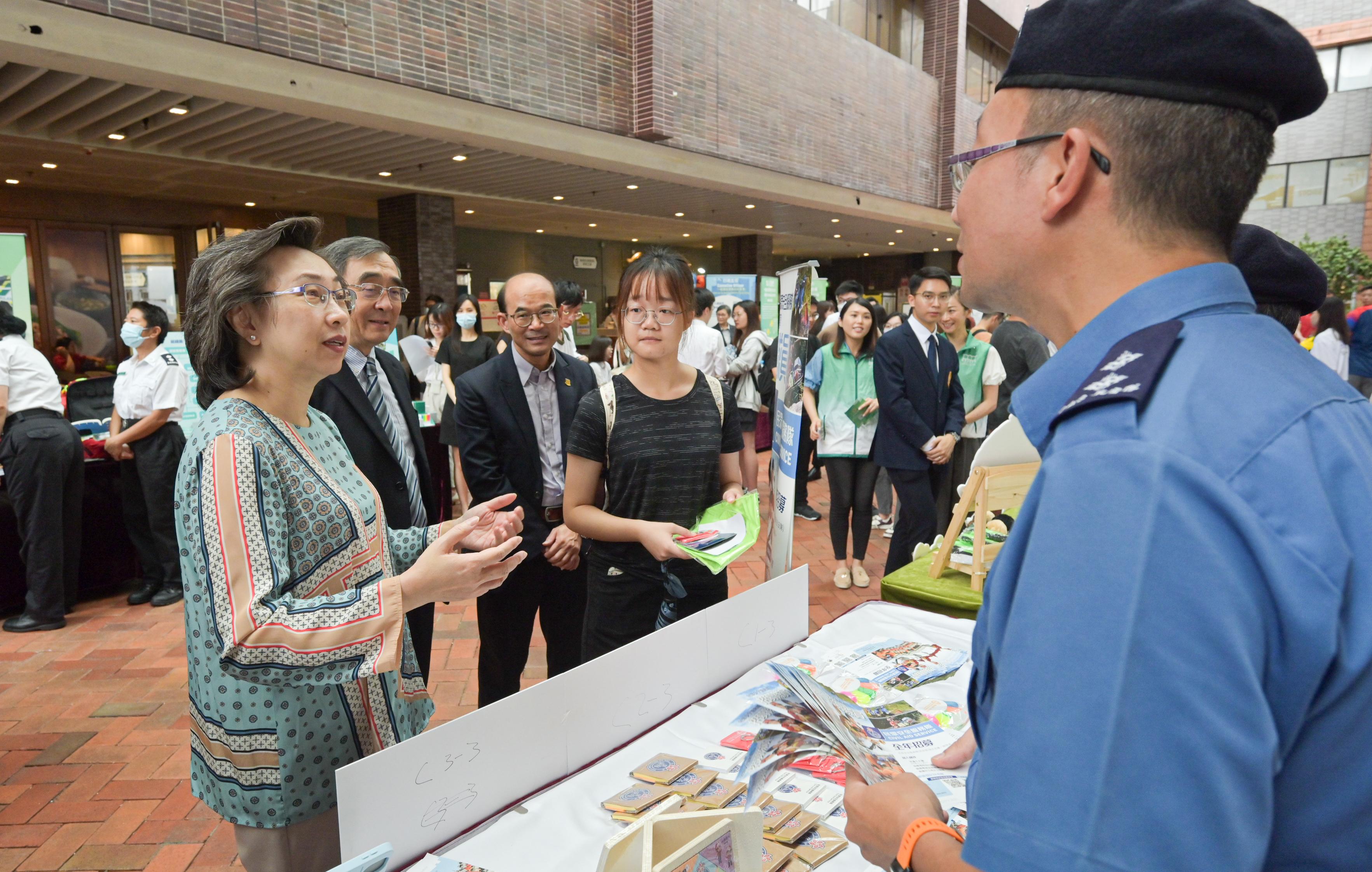The Secretary for the Civil Service, Mrs Ingrid Yeung, visited the University of Hong Kong today (September 14), where she toured the Government Career Fair being held at the campus and encouraged students to join the civil service to serve the public. Photo shows Mrs Yeung (first left) visiting the booth set up by the Civil Aid Service.
