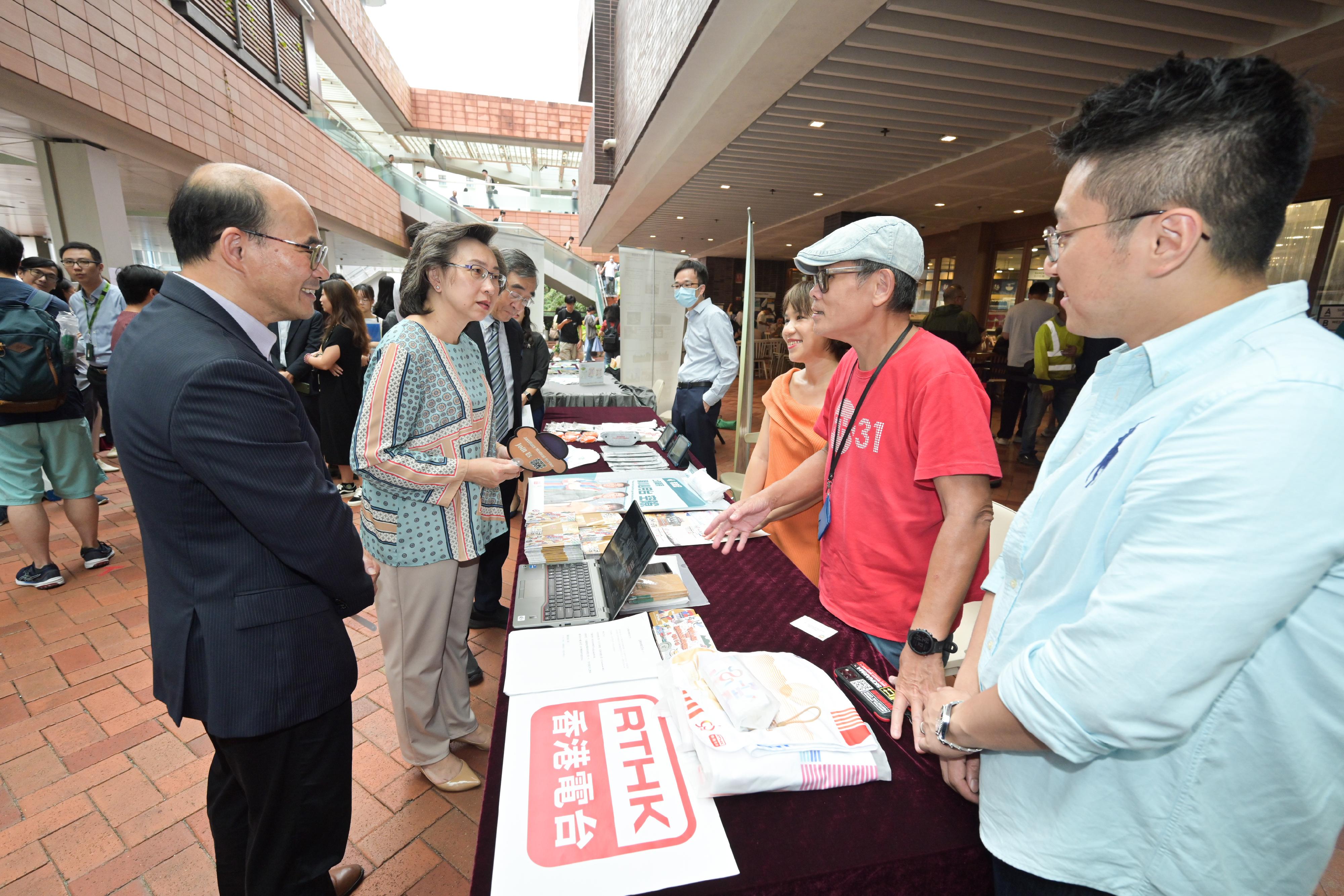 The Secretary for the Civil Service, Mrs Ingrid Yeung, visited the University of Hong Kong today (September 14), where she toured the Government Career Fair being held at the campus and encouraged students to join the civil service to serve the public. Photo shows Mrs Yeung (second left) visiting the booth set up by Radio Television Hong Kong.