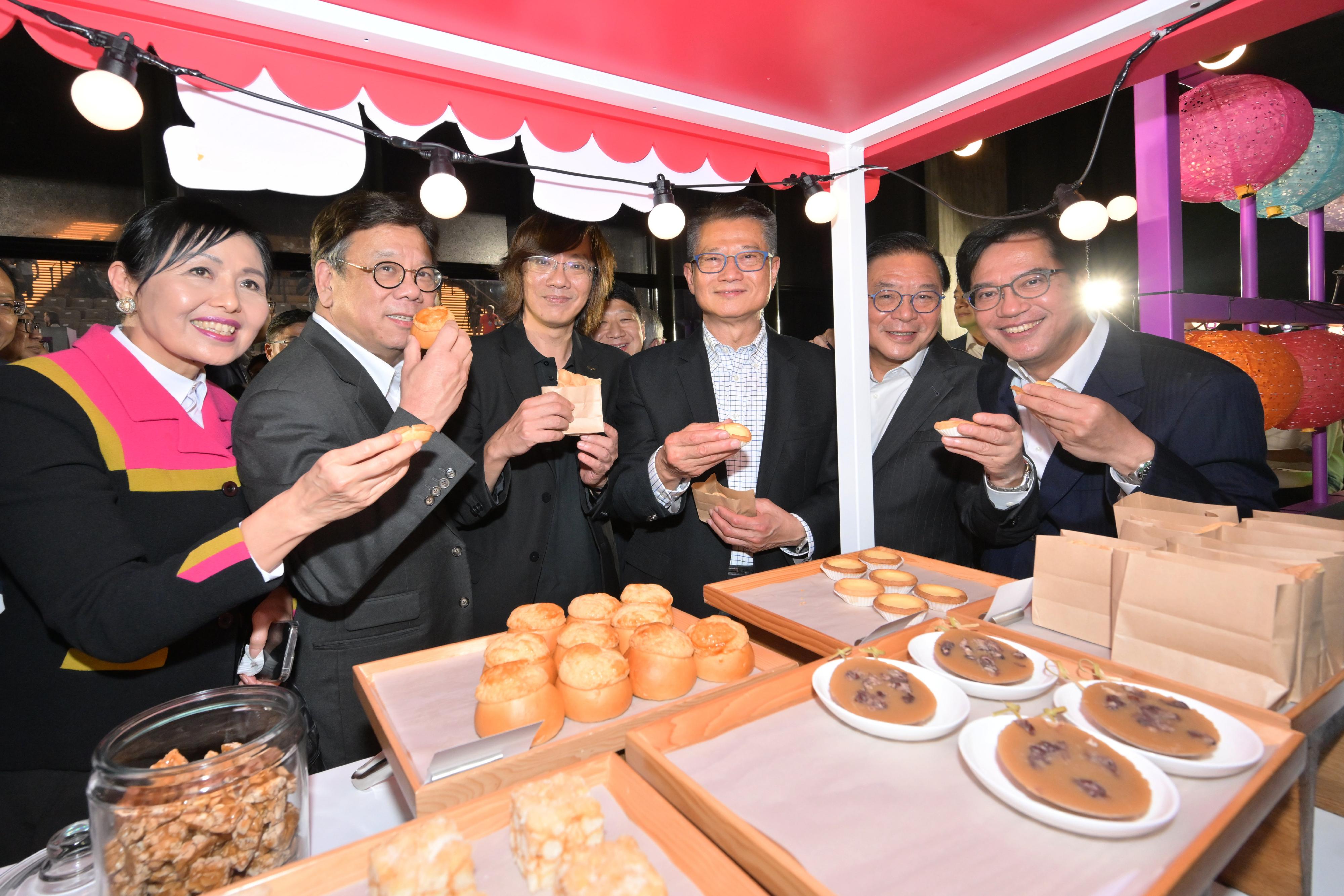 The Financial Secretary, Mr Paul Chan, attended the "Night Vibes Hong Kong" Campaign Launch Ceremony today (September 14). Photo shows Mr Chan (third right); the Deputy Financial Secretary, Mr Michael Wong (first right); the Secretary for Commerce and Economic Development, Mr Algernon Yau (second left), and other guests tasting food at a night market.