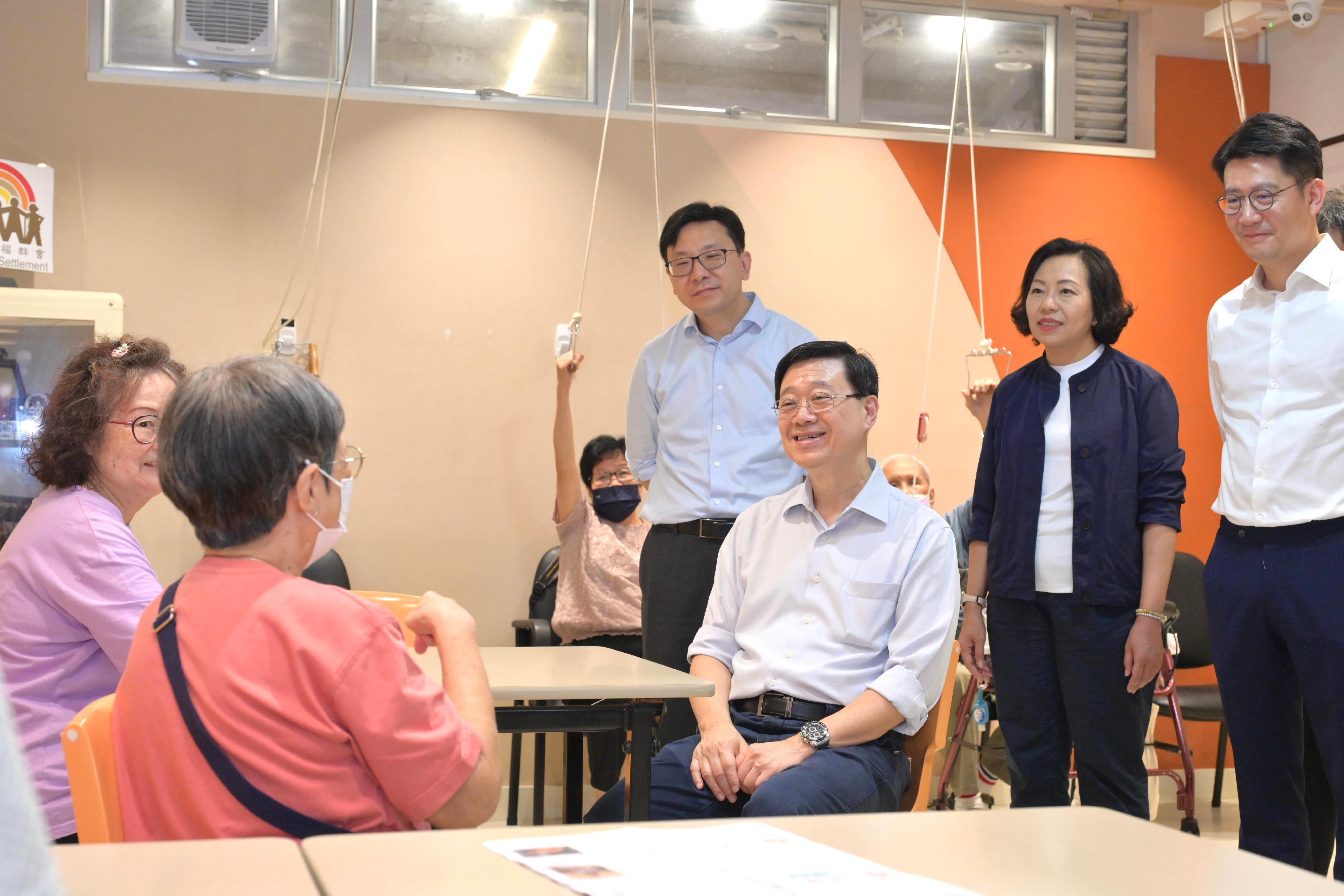 The Chief Executive, Mr John Lee, visited Tsuen Wan to gather public views on the upcoming Policy Address today (September 15). Photo shows Mr Lee (third right); the Secretary for Home and Youth Affairs, Miss Alice Mak (second right); and the Secretary for Labour and Welfare, Mr Chris Sun (fourth right), chatting with elderly people at the St. James' Settlement Project Care Neighbourhood Elderly Centre.