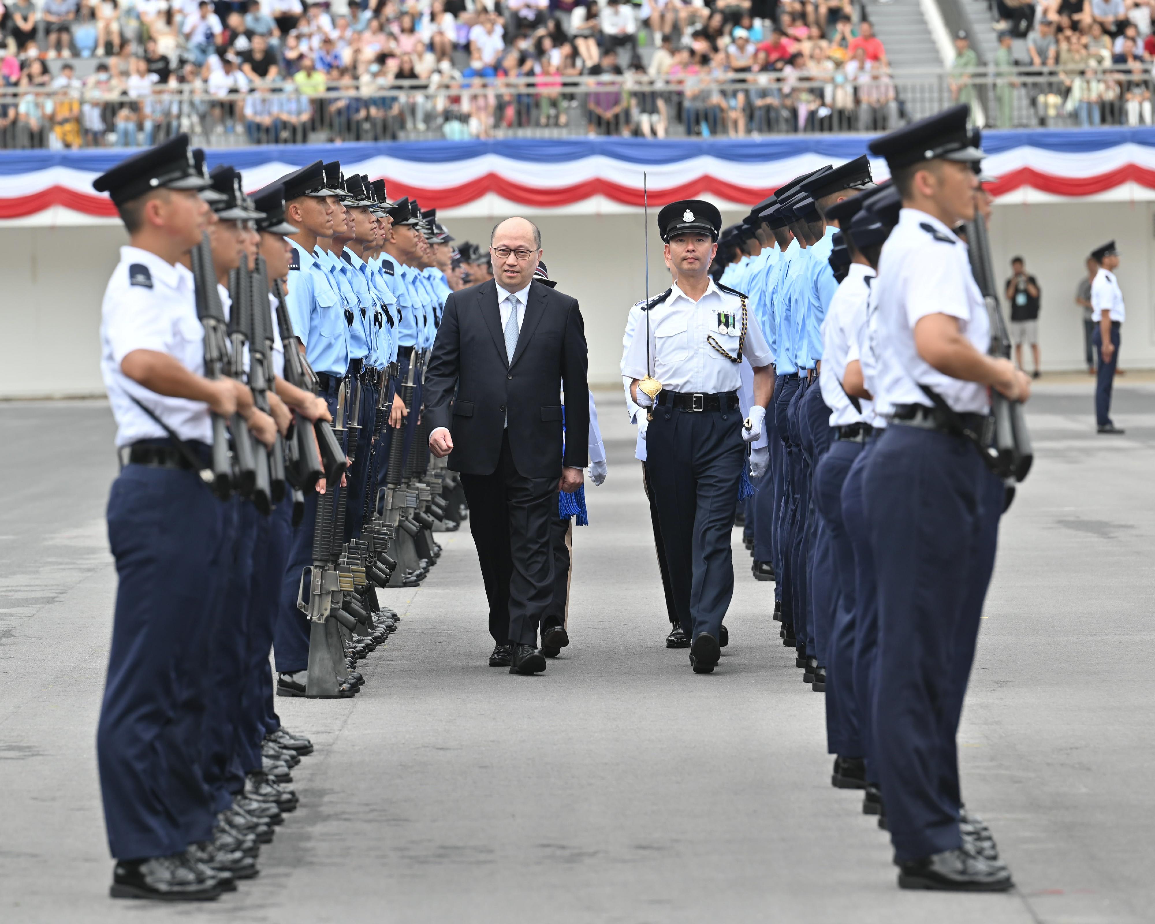 The Director of the Liaison Office of the Central People's Government in the Hong Kong Special Administrative Region, Mr Zheng Yanxiong, inspects a passing-out parade as a reviewing officer at the Hong Kong Police College today (September 16).
