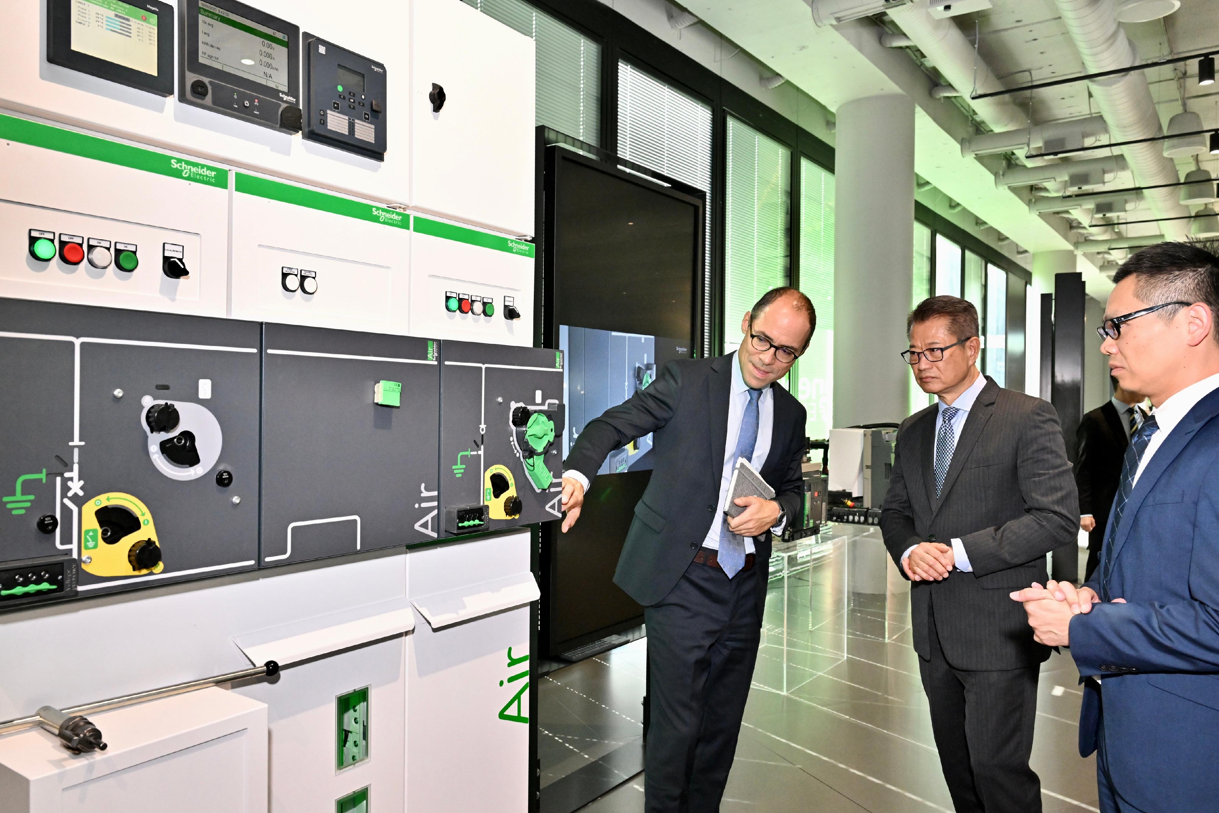 The Financial Secretary, Mr Paul Chan, visited two leading French enterprises and toured their research and development facilities yesterday (September 18, Paris time). Photo shows Mr Chan (second right) being briefed by representatives of an enterprise specialising in smart and digital energy management on its business strategies as well as its latest technological solutions and products.