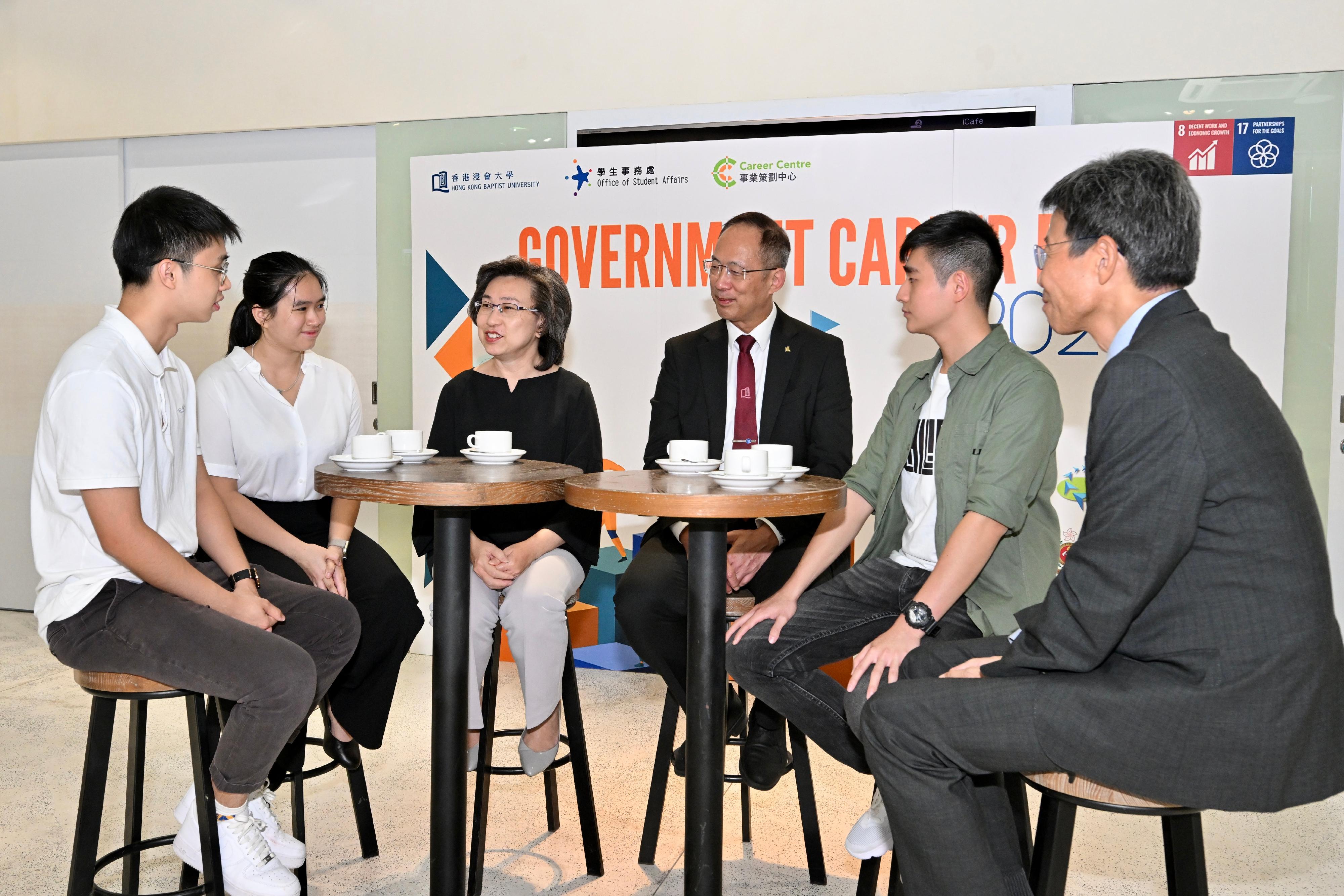 The Secretary for the Civil Service, Mrs Ingrid Yeung, visited the Government Career Fair being held at the campus of Hong Kong Baptist University (HKBU) today (September 20). Photo shows Mrs Yeung (third left); the President and Vice-Chancellor of HKBU, Professor Alexander Wai (third right); and the Vice-President (Teaching and Learning) of HKBU, Dr Albert Chau (first right), chatting with students to know their career plans and aspirations.