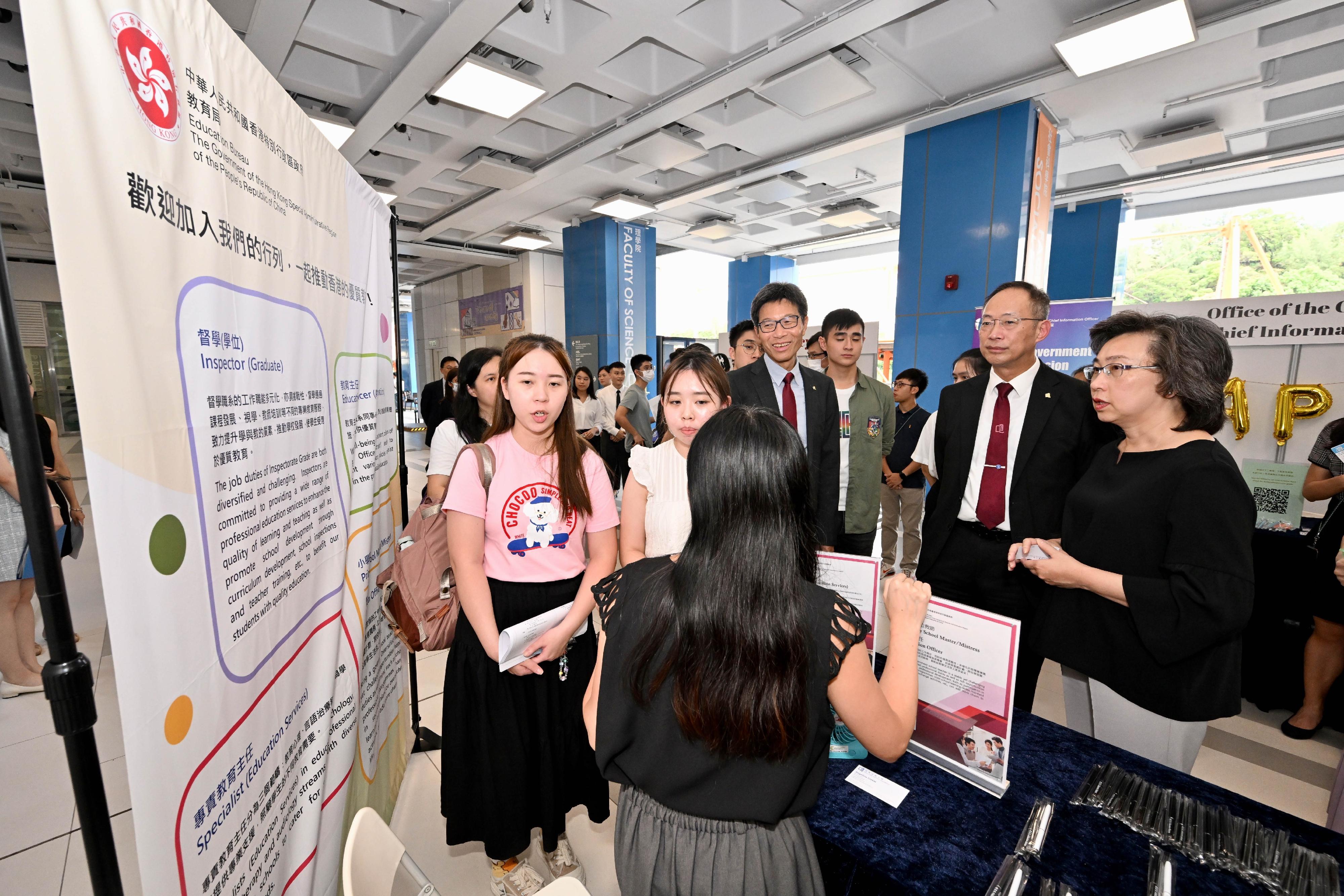 The Secretary for the Civil Service, Mrs Ingrid Yeung, visited the Government Career Fair being held at the campus of Hong Kong Baptist University (HKBU) today (September 20) to learn more about the career aspirations of students and encourage them to join the civil service and serve the community. Photo shows Mrs Yeung (first right) visiting the booth set up by the Education Bureau. Looking on is the President and Vice-Chancellor of HKBU, Professor Alexander Wai (second right).