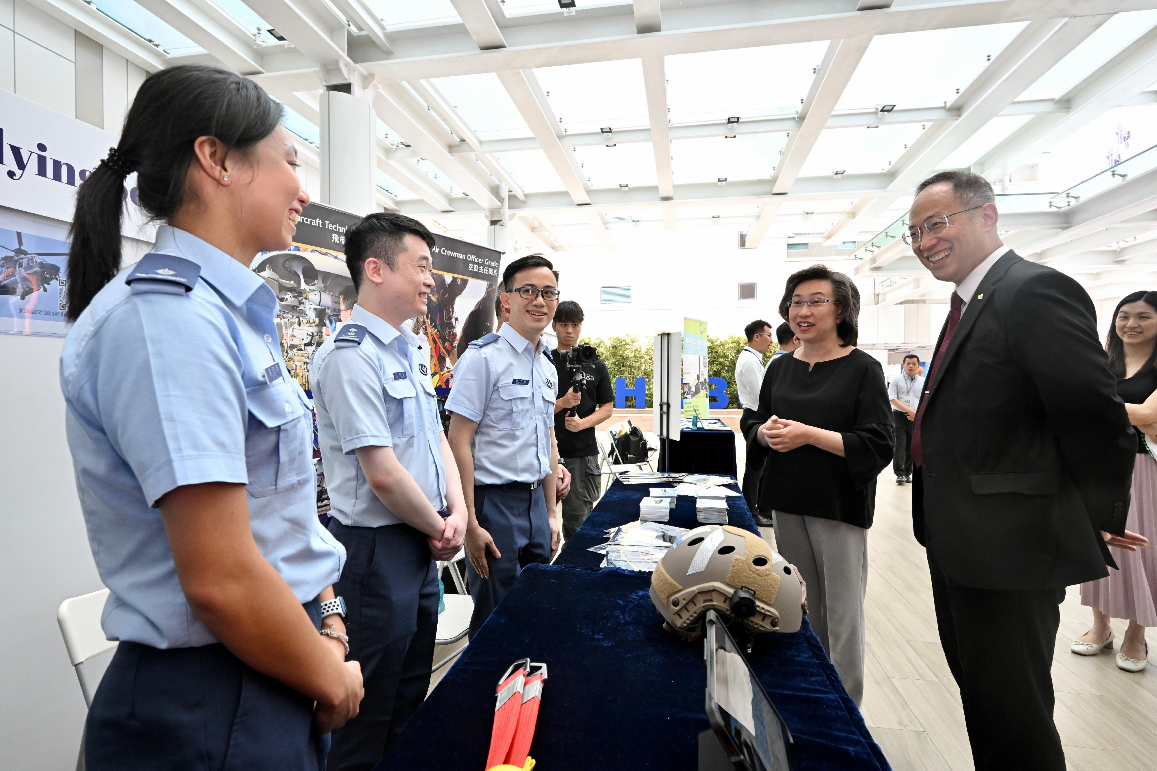 The Secretary for the Civil Service, Mrs Ingrid Yeung, visited the Government Career Fair being held at the campus of Hong Kong Baptist University (HKBU) today (September 20) to learn more about the career aspirations of students and encourage them to join the civil service and serve the community. Photo shows Mrs Yeung (second right) visiting the booth set up by the Government Flying Service. Looking on is the President and Vice-Chancellor of HKBU, Professor Alexander Wai (first right).
