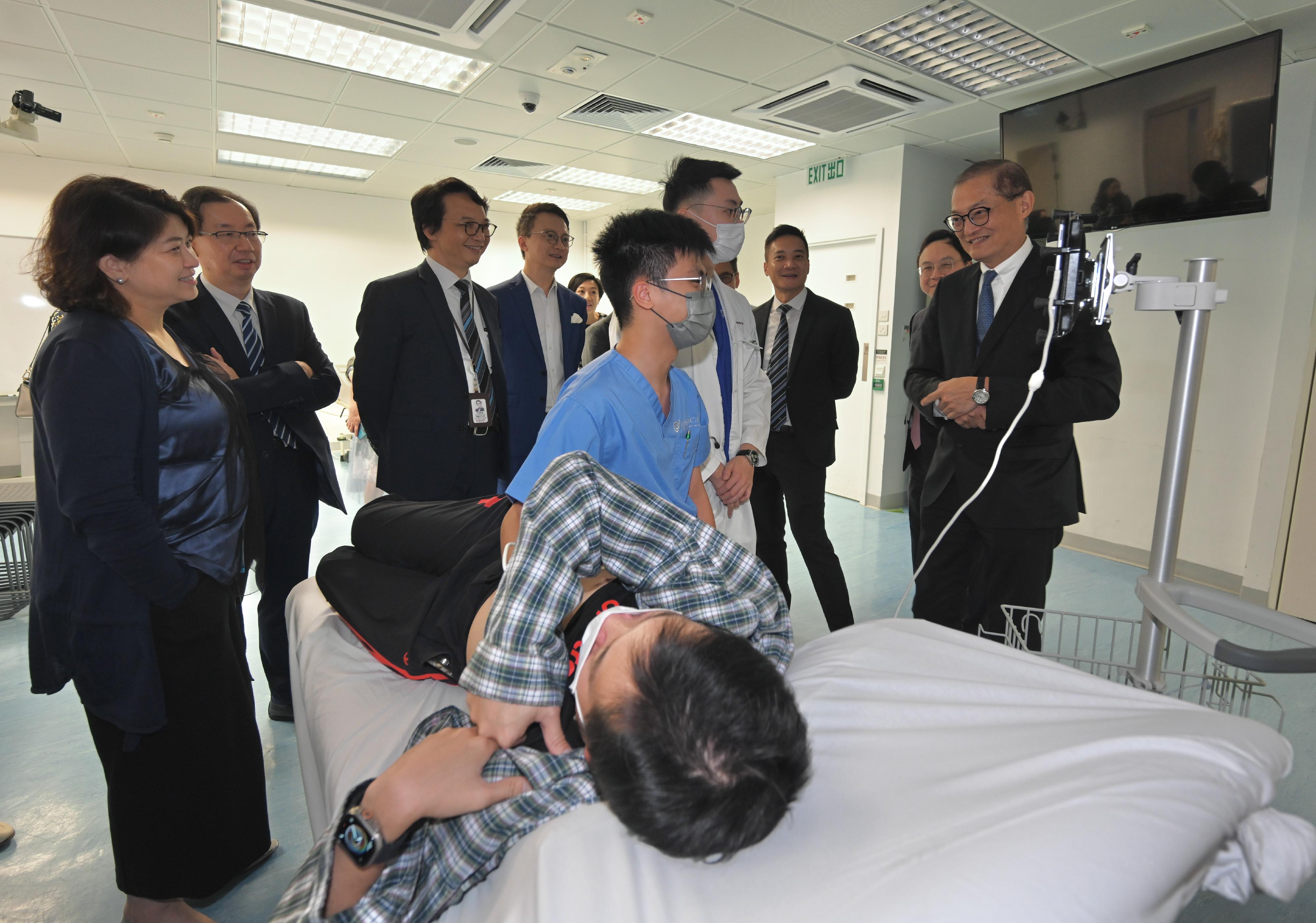 The Secretary for Health, Professor Lo Chung-mau, visited the Faculty of Medicine of the Chinese University of Hong Kong today (September 21). Photo shows Professor Lo (first right) and the Under Secretary for Health, Dr Libby Lee (first left), visiting the Kai Chong Tong Clinical Skills Learning Centre situated at Prince of Wales Hospital to get a better grasp of clinical skills teaching.