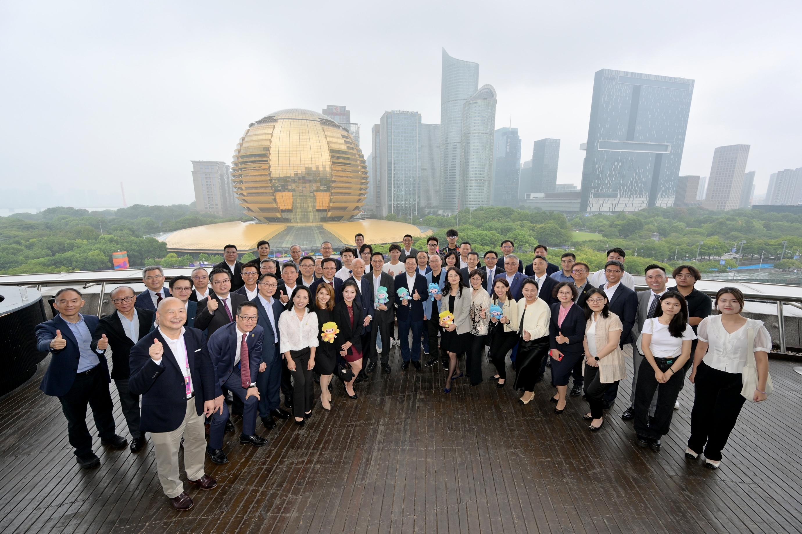 The Chief Executive, Mr John Lee, led a delegation of the Hong Kong Special Administrative Region Government to attend the opening ceremony of the 19th Asian Games Hangzhou today (September 22). Photo shows Mr Lee (first row, seventh left); the Secretary for Culture, Sports and Tourism, Mr Kevin Yeung (first row, sixth left); the Director of the Chief Executive's Office, Ms Carol Yip (first row, sixth right), with the representatives of Hong Kong enterprises in Zhejiang.
