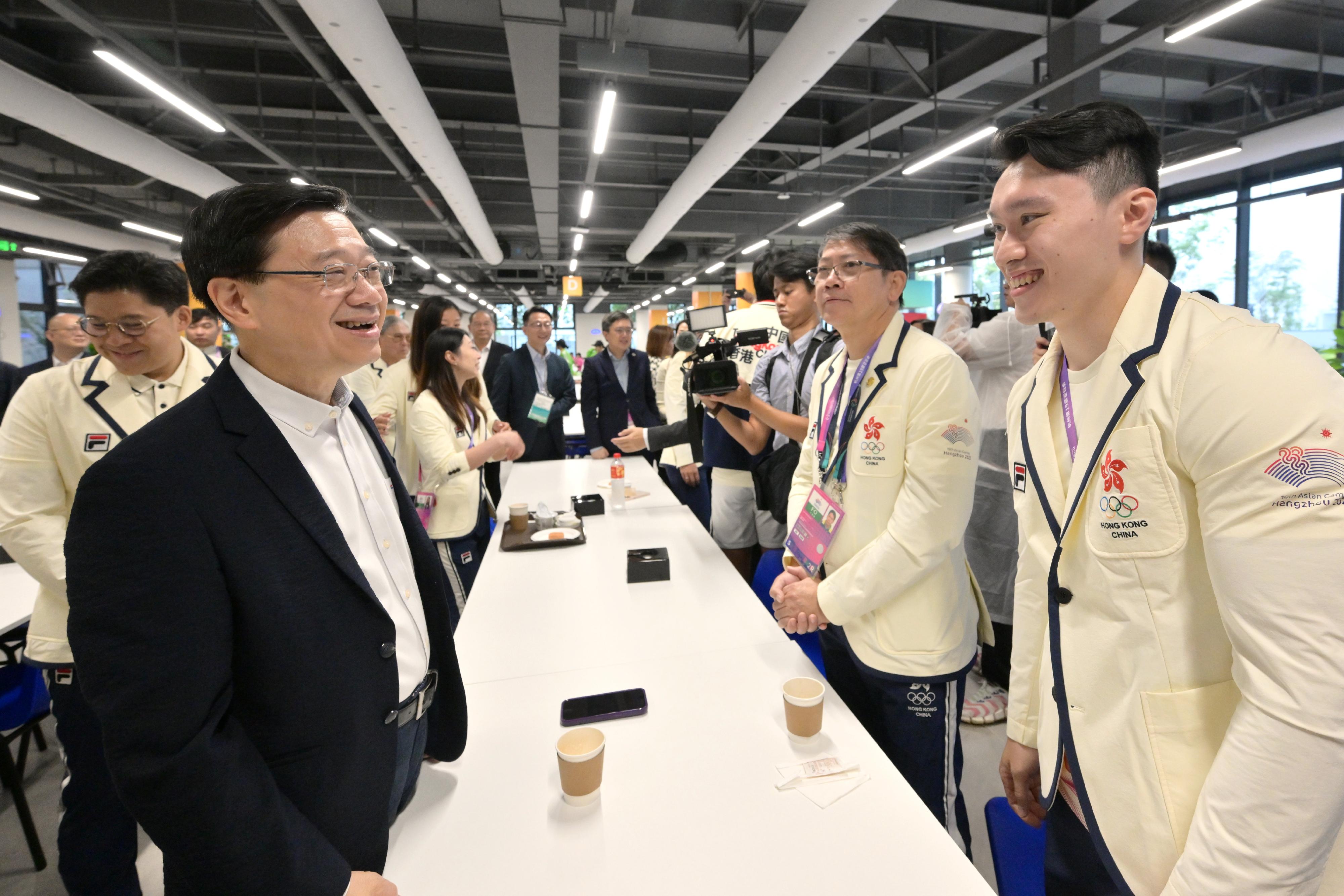The Chief Executive, Mr John Lee, led a delegation of the Hong Kong Special Administrative Region Government to attend the opening ceremony of the 19th Asian Games Hangzhou today (September 22). Photo shows Mr Lee (second left) interacting with a Hong Kong athlete.