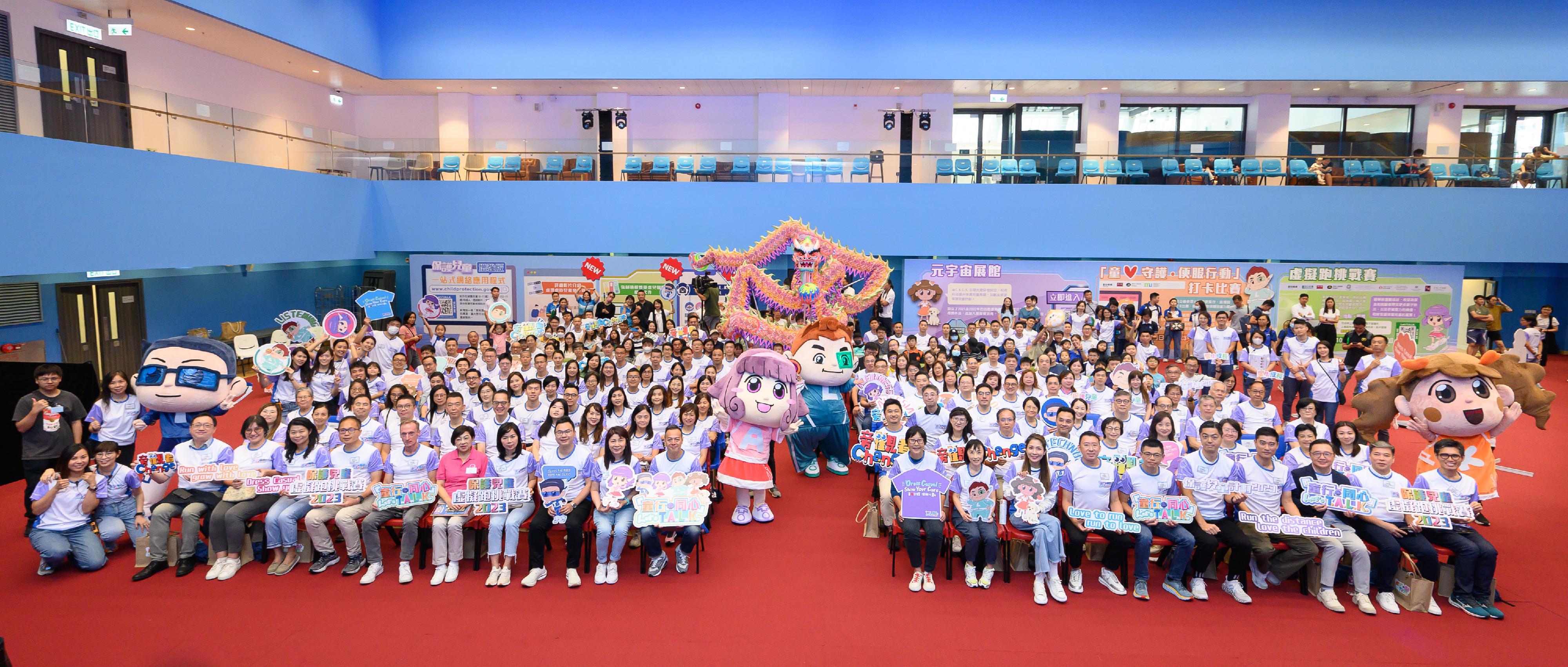 The Hong Kong Police Force held the opening ceremony of "Let's T.A.L.K. - Child Protection Campaign 2023" today (September 23). Picture shows the officiating guests taking a group photo with participants and campaign mascots.