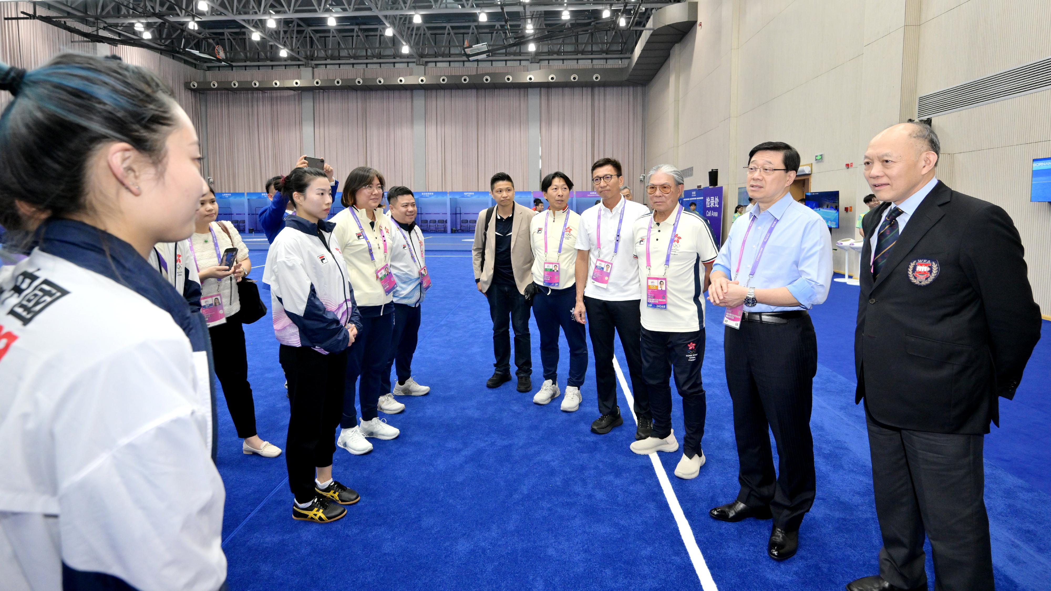 The Chief Executive, Mr John Lee, led a Hong Kong Special Administrative Region Government delegation to Hangzhou and continued his visit programme today (September 24). Photo shows (from second right) Mr Lee; the President of the Sports Federation & Olympic Committee of Hong Kong, China, Mr Timothy Fok, and the Commissioner for Sports in the Culture, Sports and Tourism Bureau, Mr Sam Wong, chatting with Hong Kong wushu athletes.