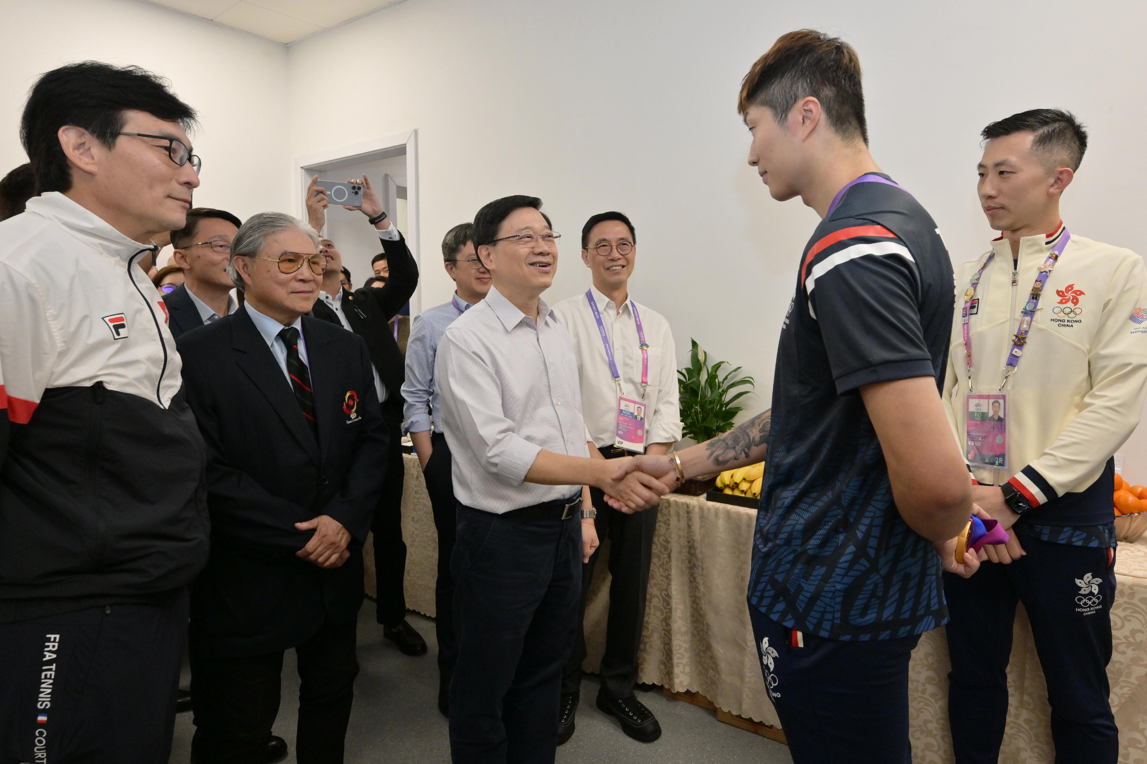 The Chief Executive, Mr John Lee, led a Hong Kong Special Administrative Region Government delegation to Hangzhou and continued his visit programme on September 24. Photo shows Mr Lee (third left) congratulating fencing athlete Cheung Ka-long on winning a gold medal in Men's Foil Individual at the 19th Asian Games Hangzhou.