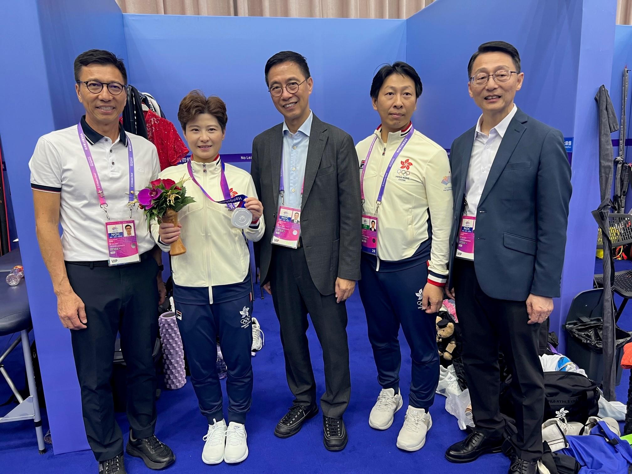 The Secretary for Culture, Sports and Tourism, Mr Kevin Yeung (centre), today (September 25) congratulated Liu Xuxu (second left), on winning a silver medal in Wushu Women's Changquan at the 19th Asian Games Hangzhou.