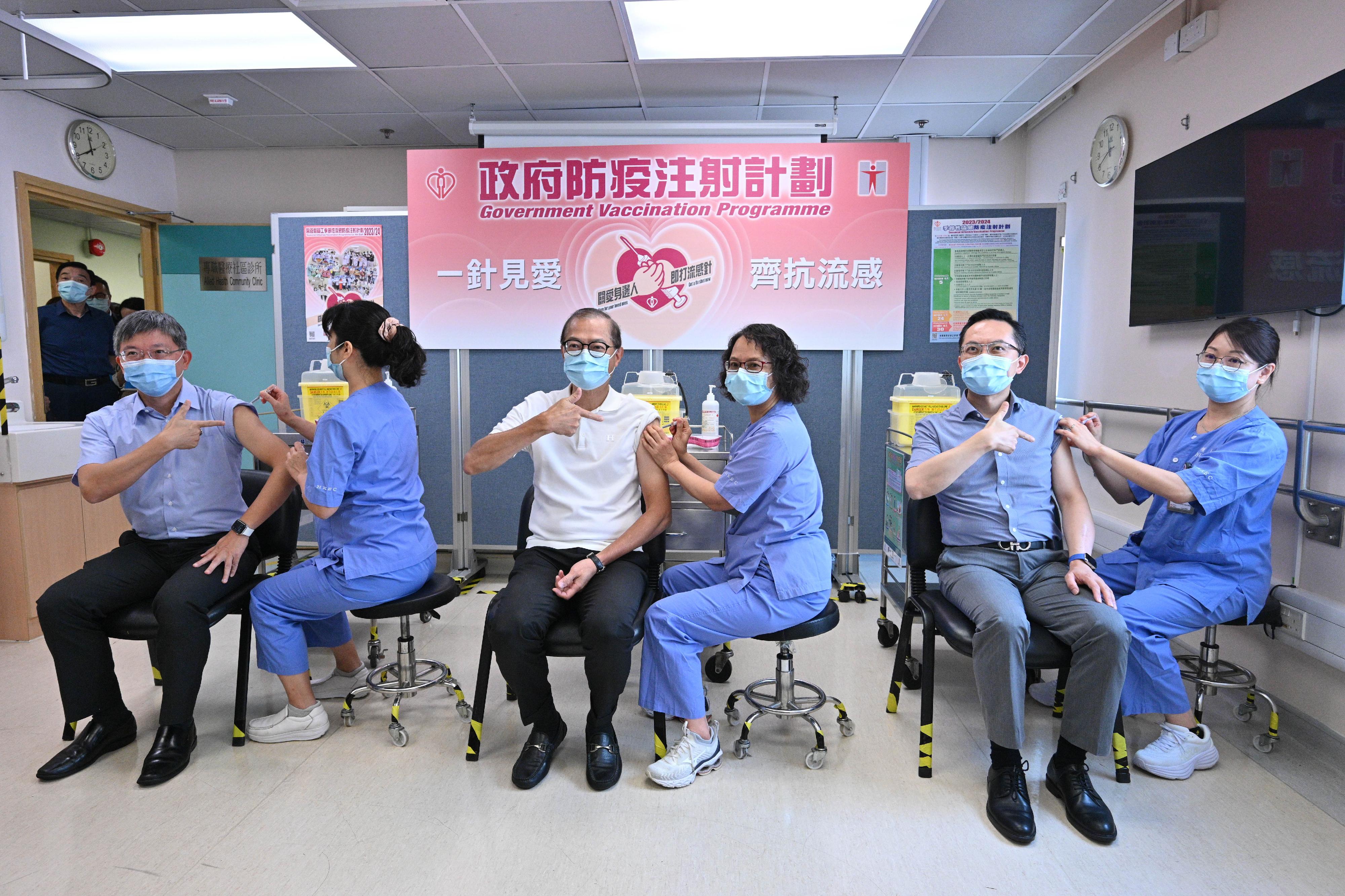 The Secretary for Health, Professor Lo Chung-mau (third left); the Permanent Secretary for Health, Mr Thomas Chan (first left); and the Director of Health, Dr Ronald Lam (second right), receive the seasonal influenza vaccination at the Sai Wan Ho General Out-patient Clinic today (September 28).